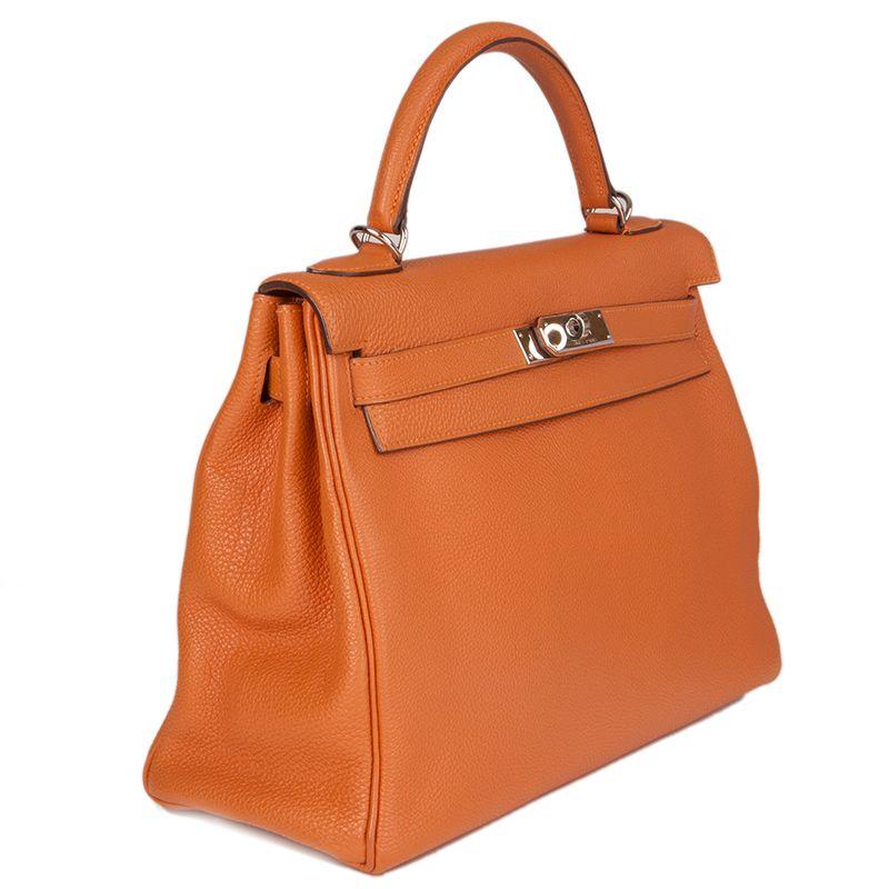 Hermes 'Kelly II 32 Retourner' bag in orange Veau Togo leather with gold-plated hardware. The interior is lined in Chevre (goat skin) with a divided open pocket against the front and a zipper pocket against the back. Has been carried and is in