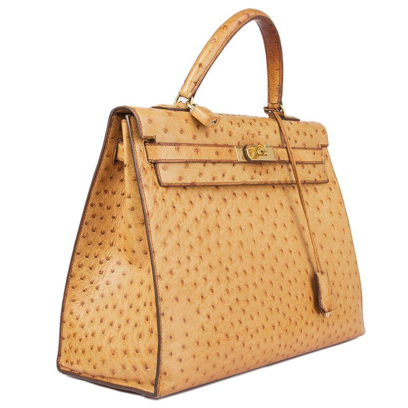 Hermès 'Kelly I 35 Sellier' Bag in Saffron ostrich. Lined in chevre (goat skin) with two open pockets against the front and a zipper pocket against the back. Has been carried with some overall signs of color fading. In overall excellent vintage
