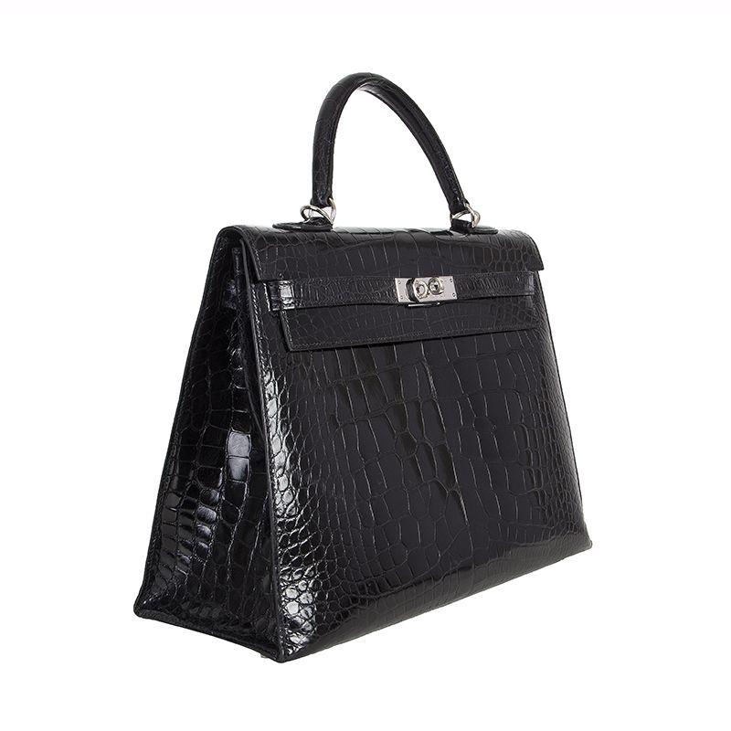 Hermes 'Kelly 35 Sellier' bag in black crocodile. Lined in black Chevre (goatskin) with two open pockets against the front and an open pocket against the back. Has been carried with minor signs of use (small surface marks and scratches consistent