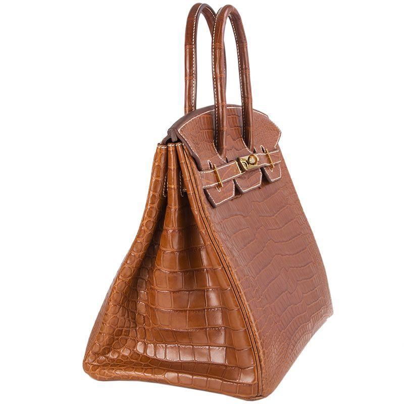 Hermes 'Crocodile Birkin 35' in Fauve (cognac) matte porosus crocodile with contrasting white stitching. Lined in Chevre (goat skin) with an open pocket against the front and a zipper pocket against the back. Has been carried and is in excellent