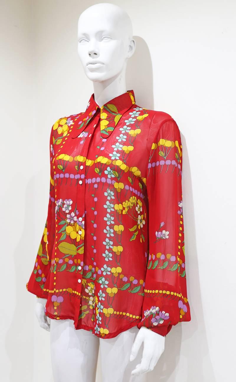 Chiffon 1970s blouse by Jeff Banks with large cuffs, bishop sleeves and button up closure.

Medium