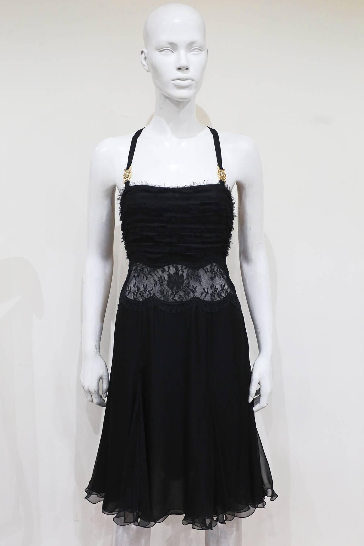 A beautiful Versace bondage silk evening dress. The dress features four gold Medusa medallions in a style of a bondage harness, lace sheer panel around waist, built in boned bra, pleated chiffon bust and pleated skirt. 

It 44 - Fr 40 - M