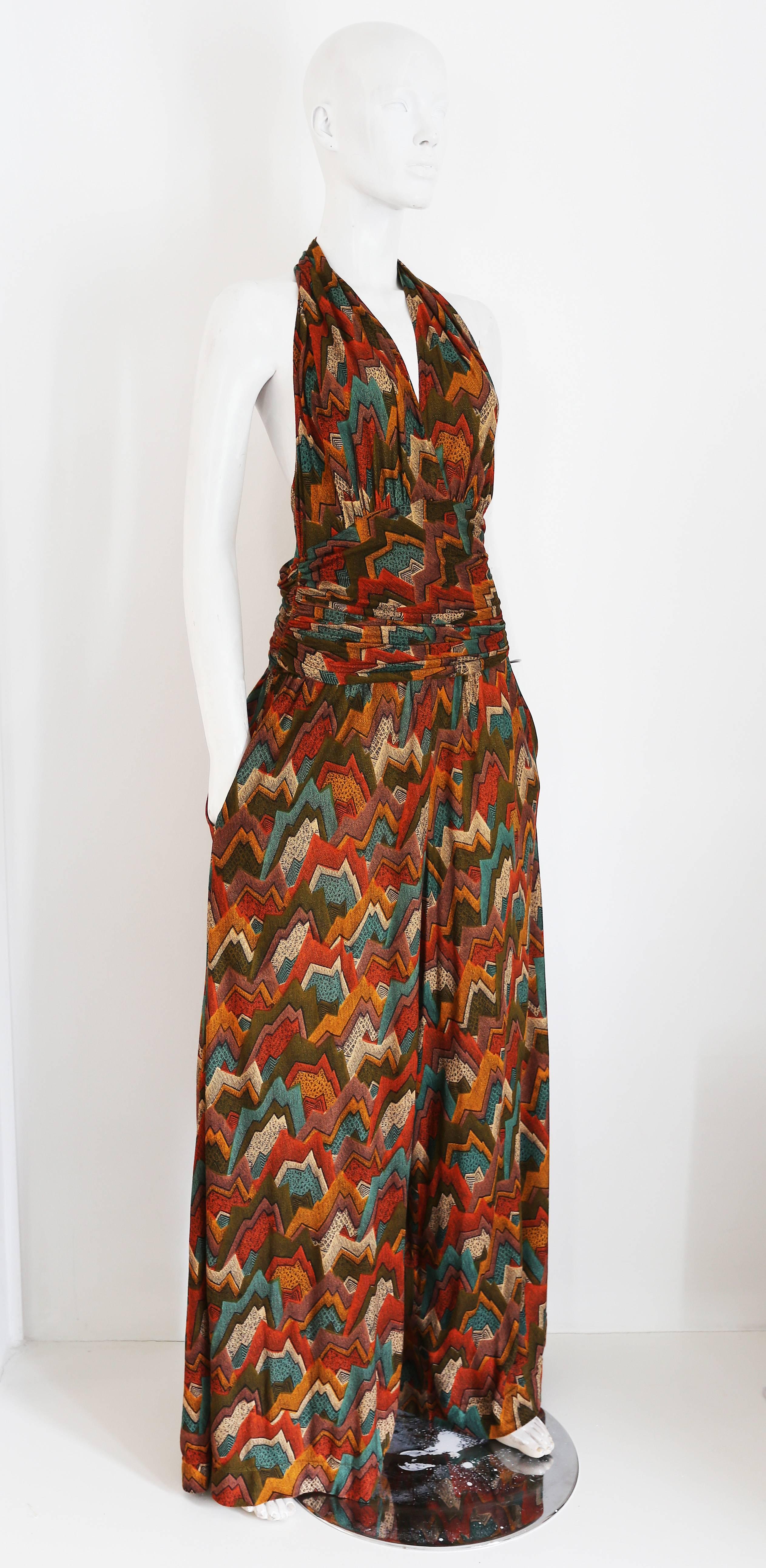 A great wide leg halter neck jumpsuit, circa 1970s. The jumpsuit has an open back and two side pockets.

Waist 28 inches