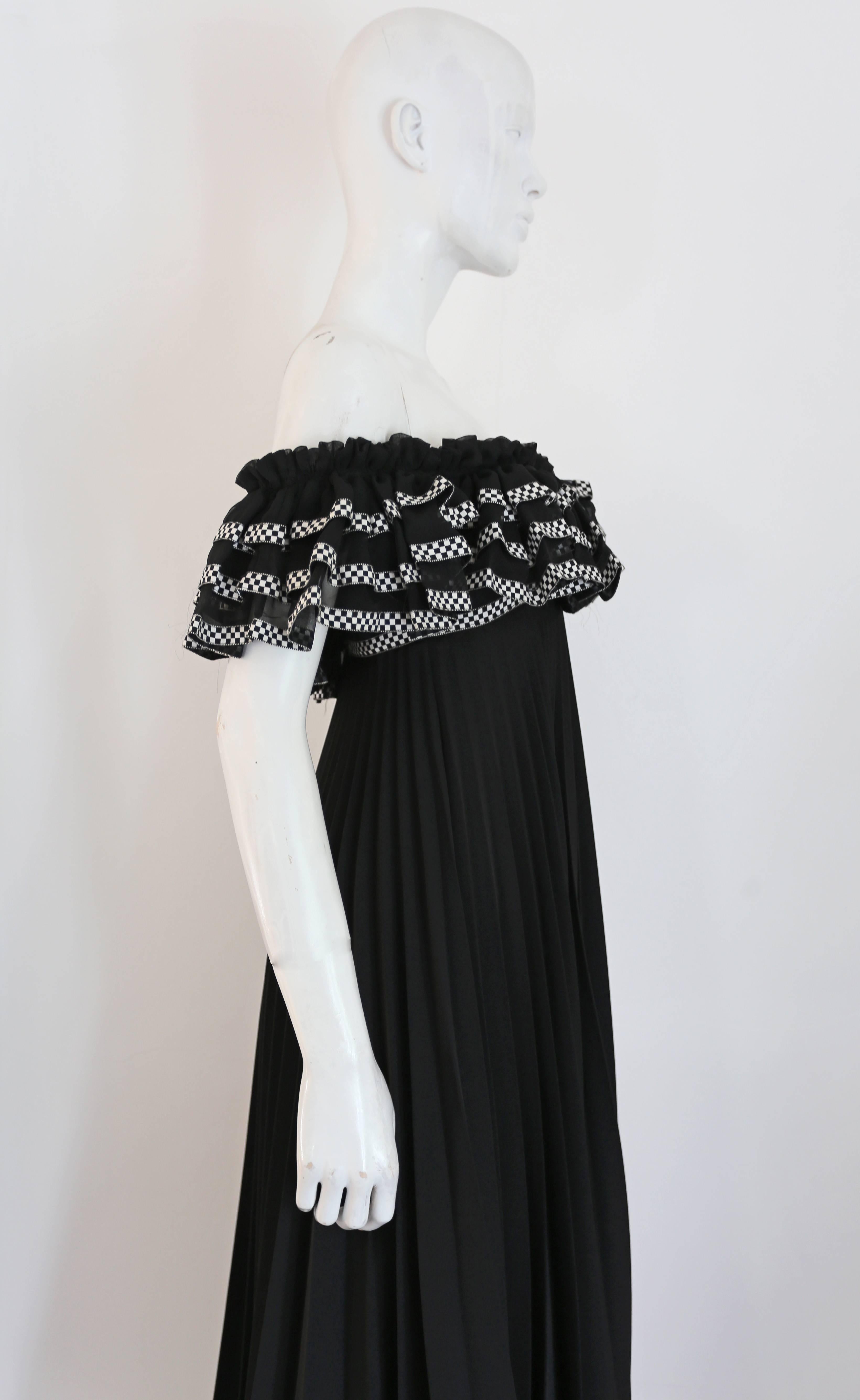 A beautiful Jean Varon pleated evening gown, circa 1970s. The gown features elasticated bust and arm holes, tiered ruffled bust with checkered trim and full pleated maxi skirt. 

Bust 32 inches

