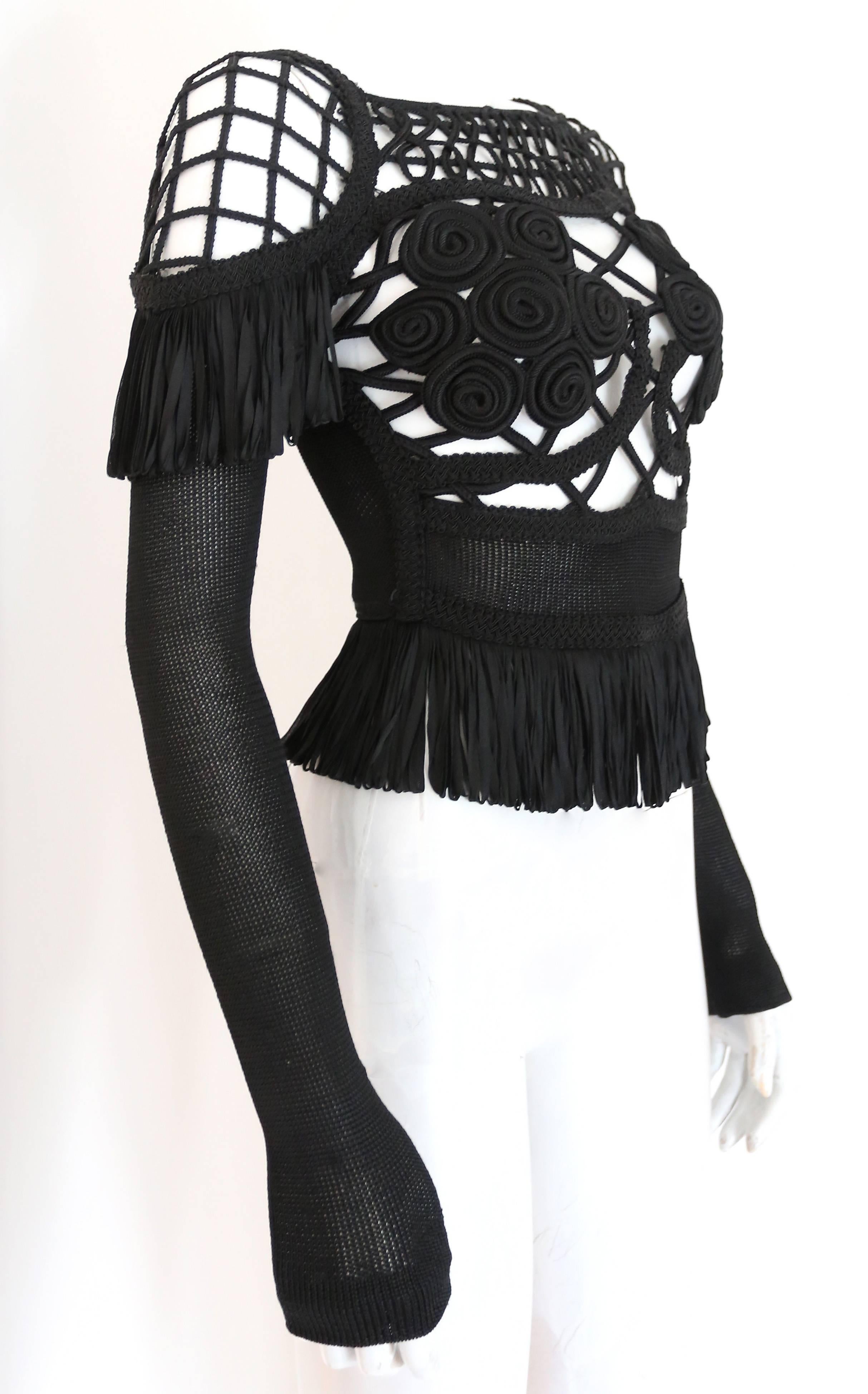 An exceptional Christian Lacroix black knitted viscose evening sweater with fringed trim and caged design on shoulders and bust. 

Bust 34