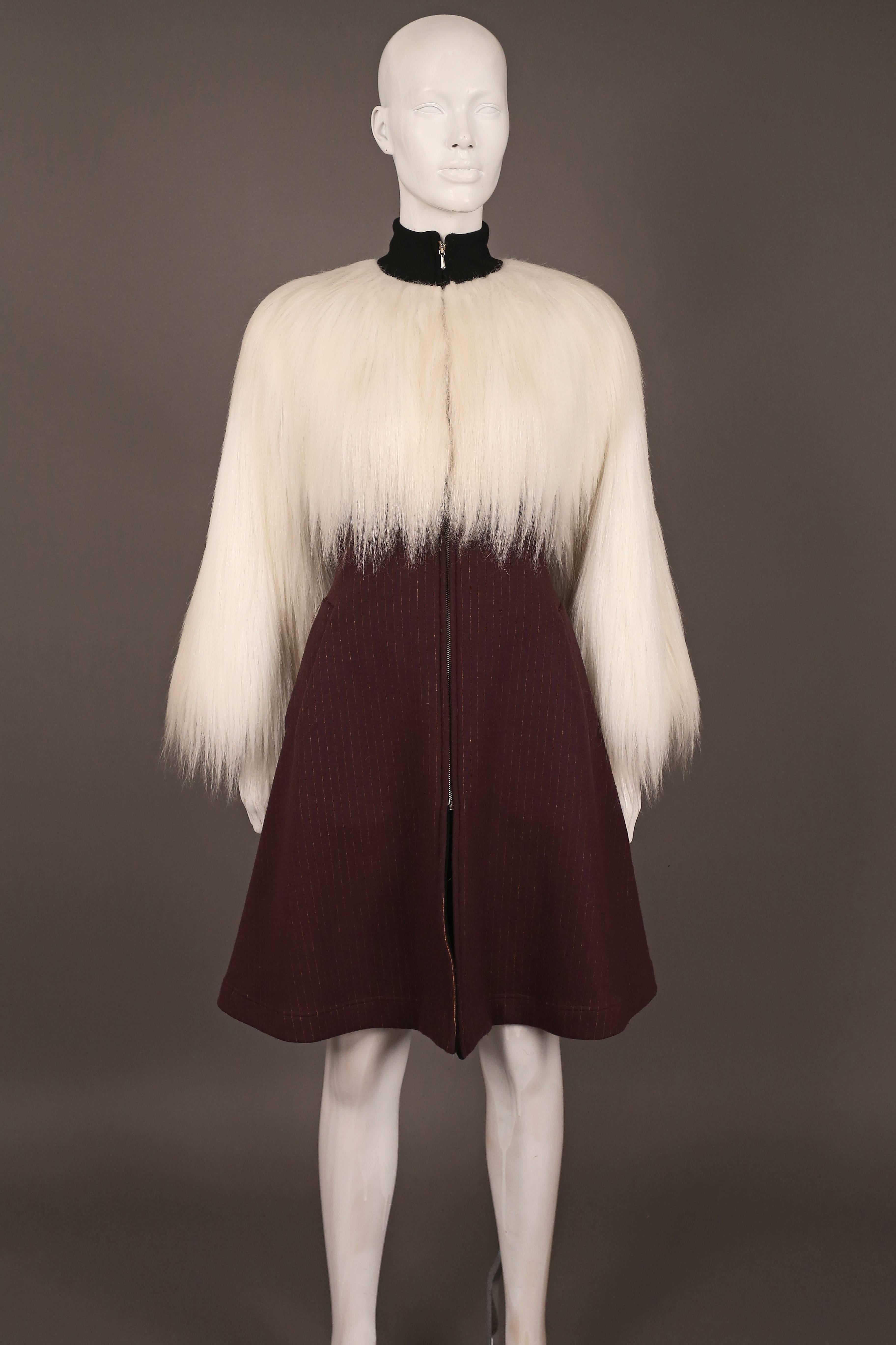 Extraordinary Jean Paul Gaultier dress coat, circa 1993. The coat features oversized white faux fur bust and sleeves, black wool turtle neck, pinstripe flared skirt and zip metal closure. 

IT 42  EU 38  UK 10 

 Wool, cotton, elastic and new
