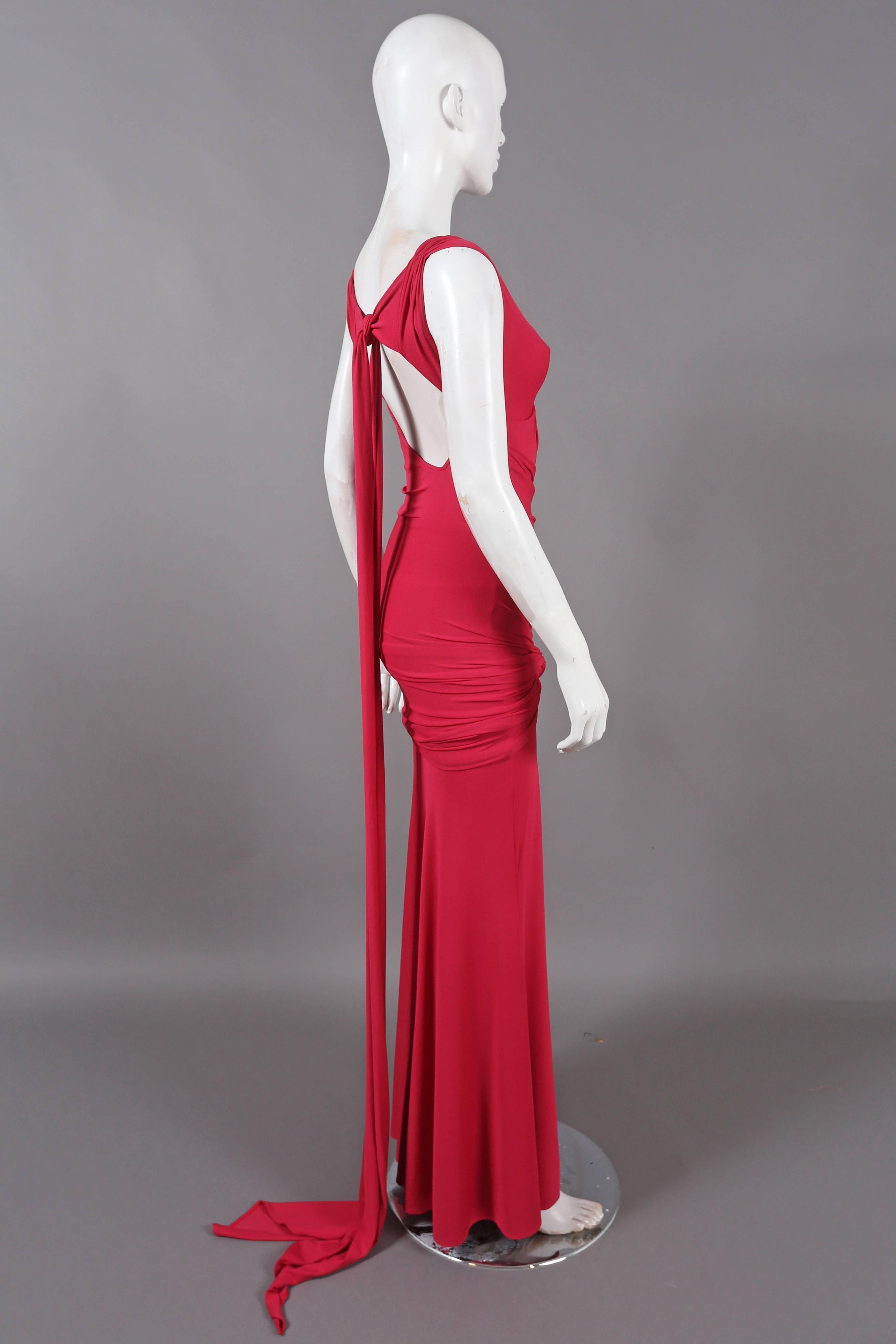 Magenta evening gown by DONNA KARAN, the dress feature 1930's inspired drapery and knotting, open back and long sash train. The dress can be styled in various ways. 

