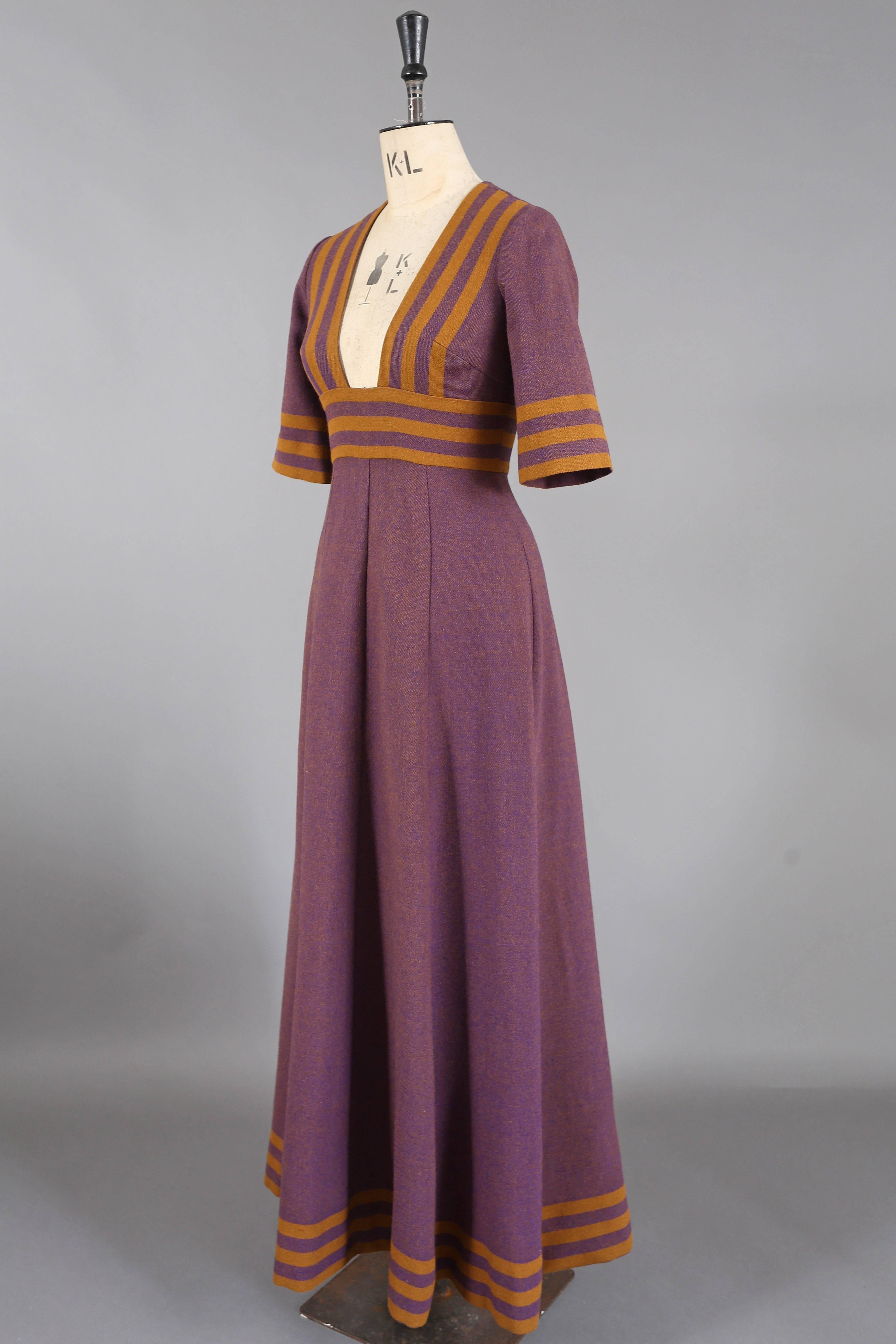 A tweed maxi dress by Jean Varon, circa 1960s. The dress features a low cut cleavage down to the waist, cropped sleeves and zip closure. 

Bust 34