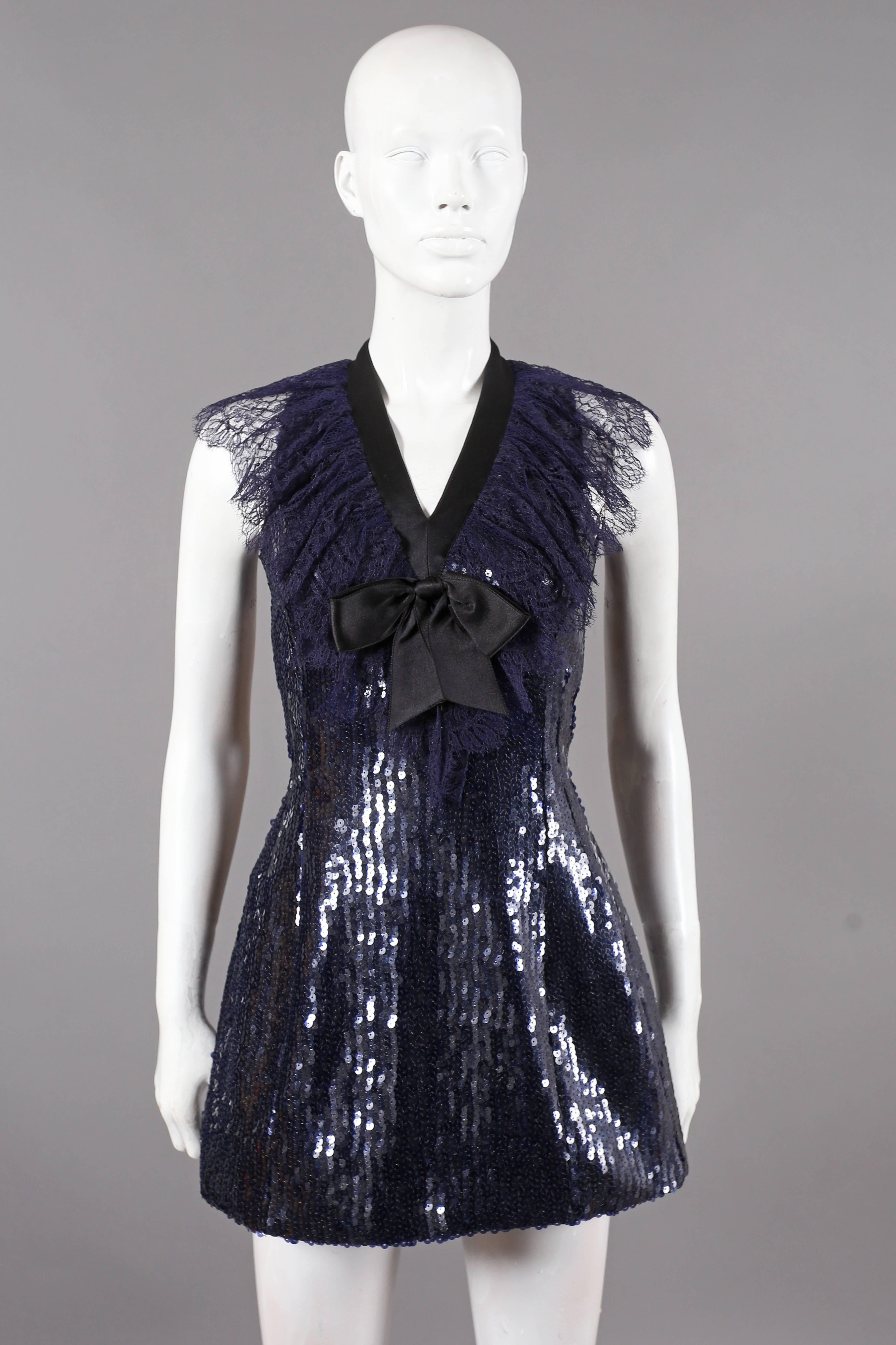 A fine and rare Chanel navy blue mini dress, circa 1987. The dress features black satin bow, Chantilly lace collar, two gold-tone clover leaf buttons and invisible zipper at rear. 

EU 36  UK 8  Small 

Bust 32