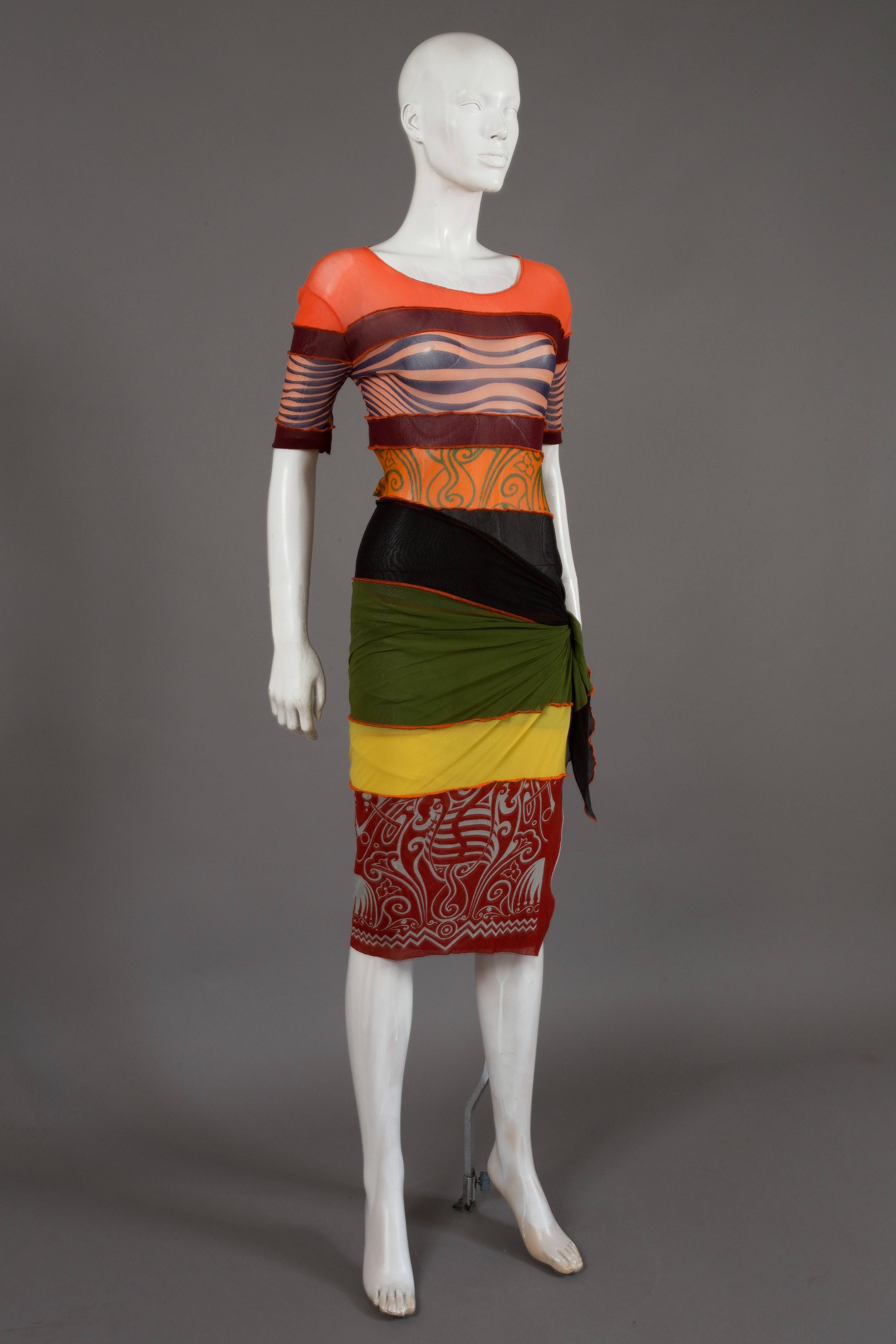 Iconic and rare Jean Paul Gaultier mesh pareo dress, spring/summer 1996. The dress features a patchwork mesh design featuring iconic Gaultier prints including the optical illusion breasts. 

Medium