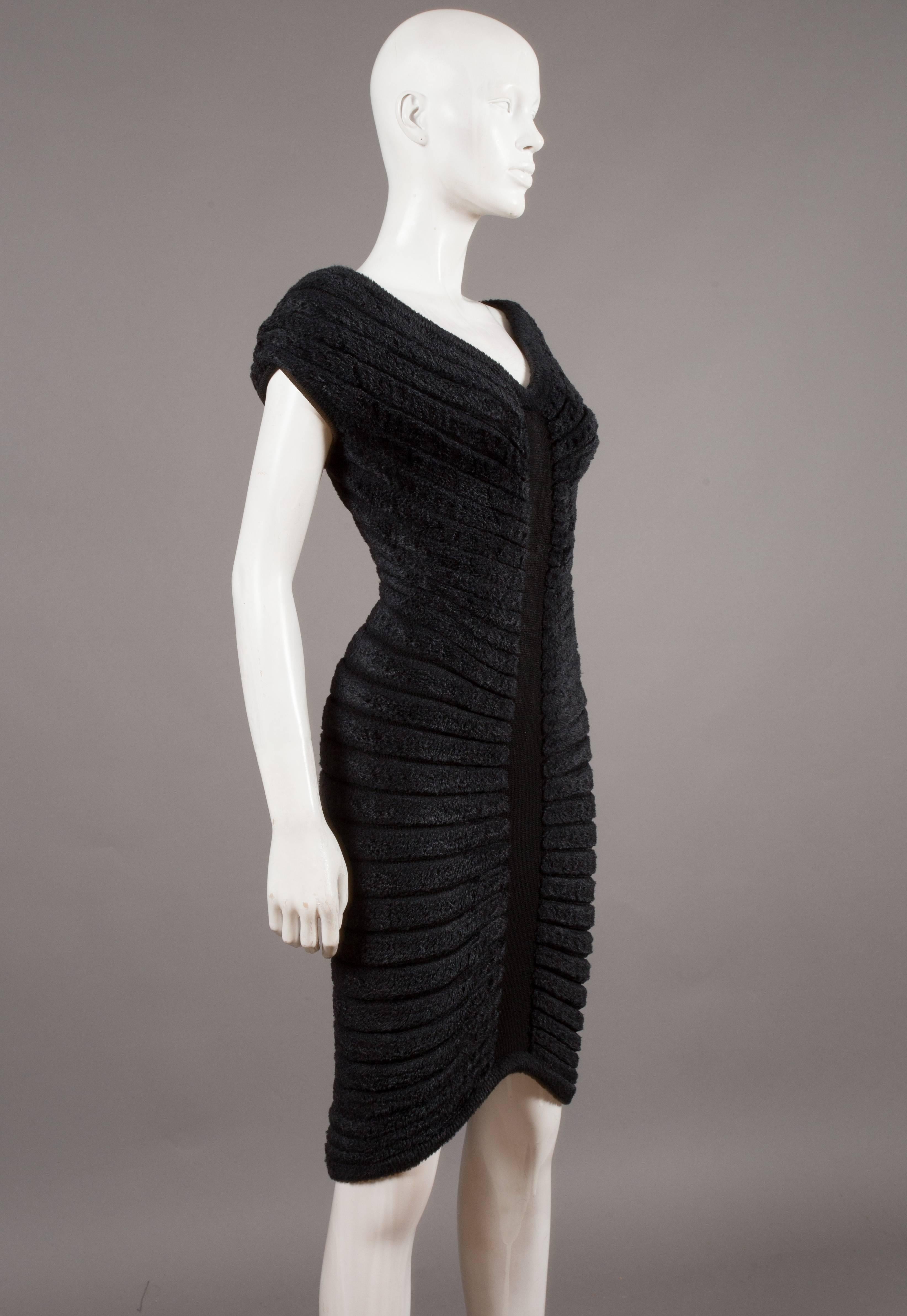 Iconic and rare Alaia black chenille-knitted evening dress, spring-summer, 1994.   Sculpted and figure-hugging with radiating concentric chenille bands.   

