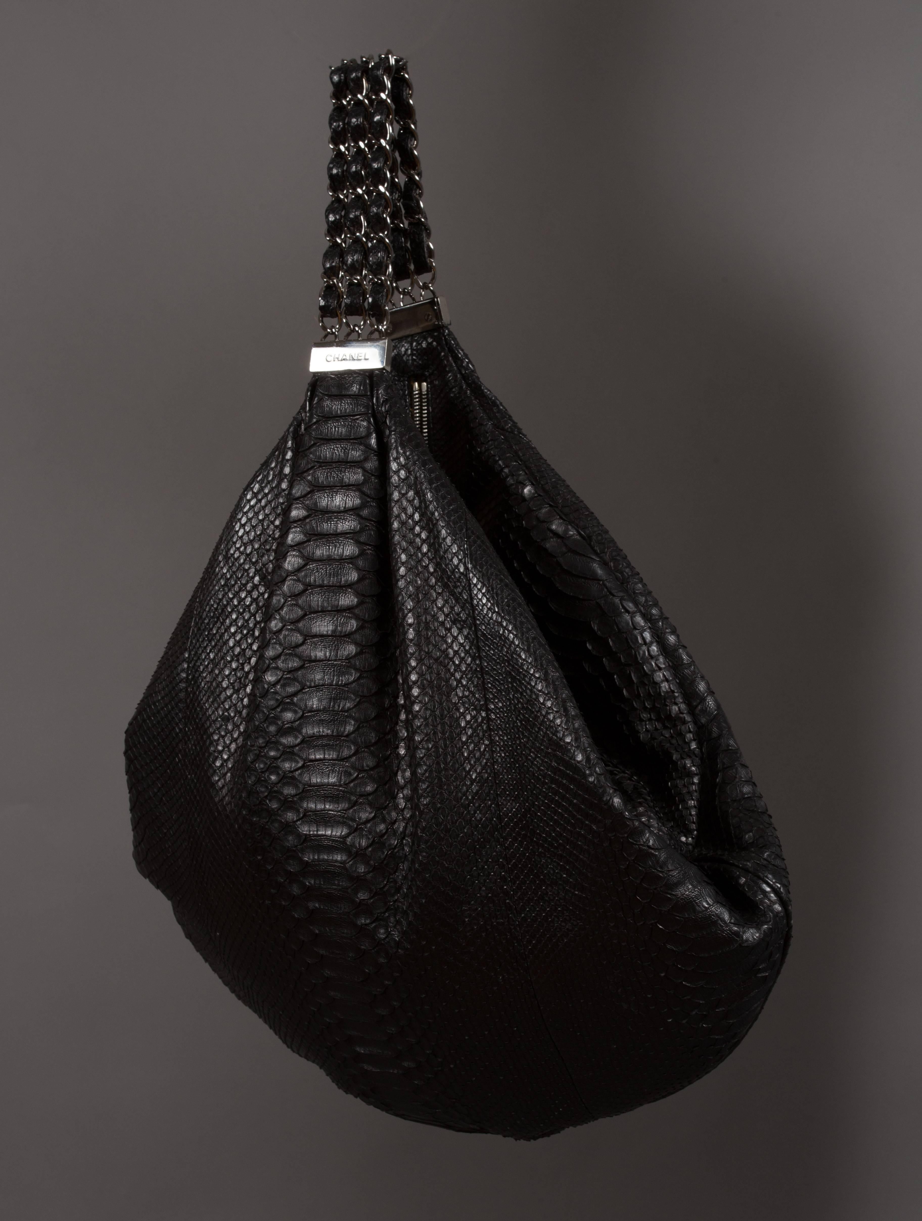 Limited edition Chanel hobo bag designed by Karl Lagerfeld, spring-summer 2007 runway collection. Black king python skin, silver hardware, 'CC' logo keychain, zip closure, satin lining, and three strand chain shoulder strap. The bag was first shown
