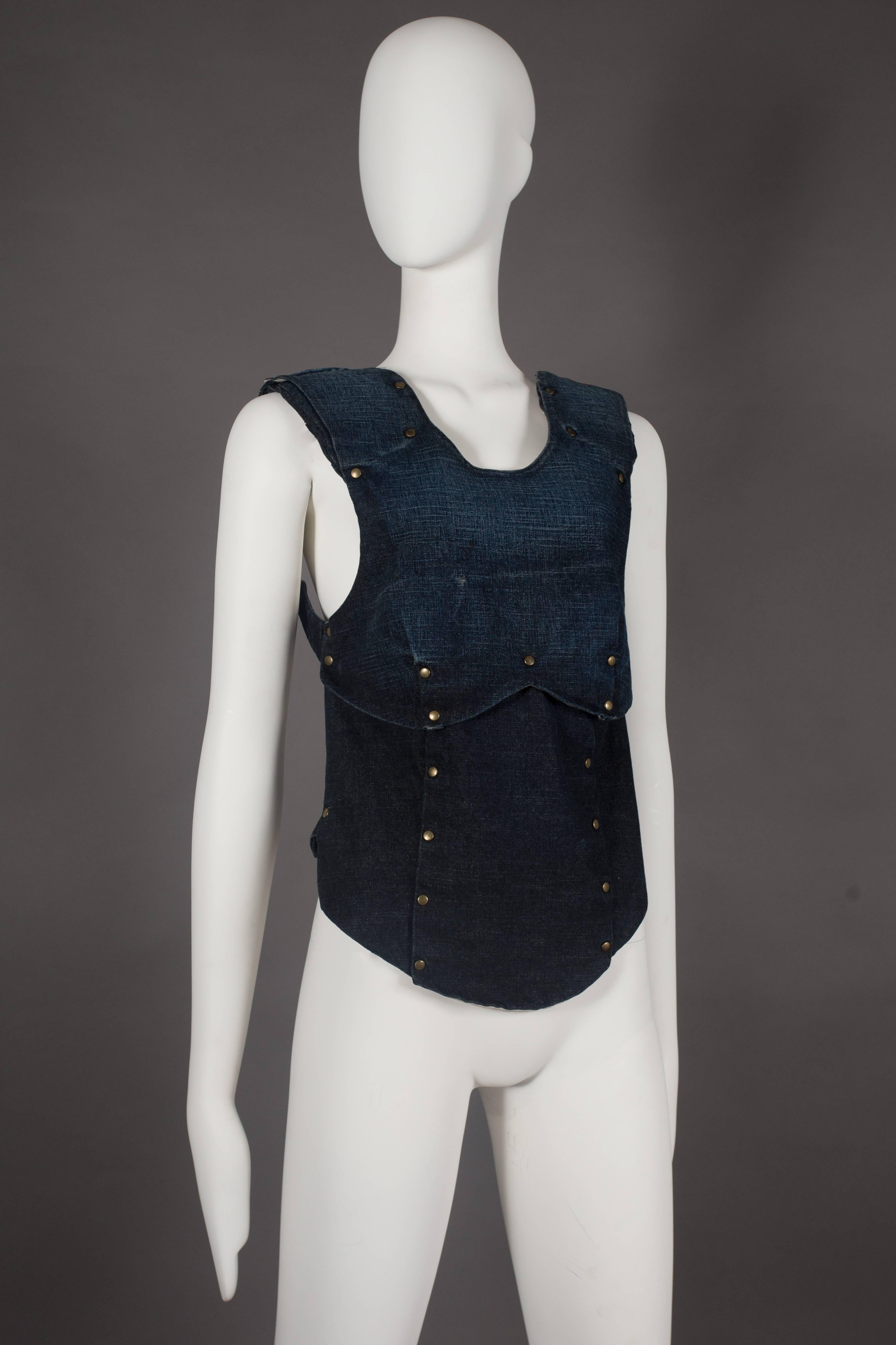 A rare A.F. Vandevorst backless armour vest in indigo distressed denim with metal studs, spring summer 2001. 