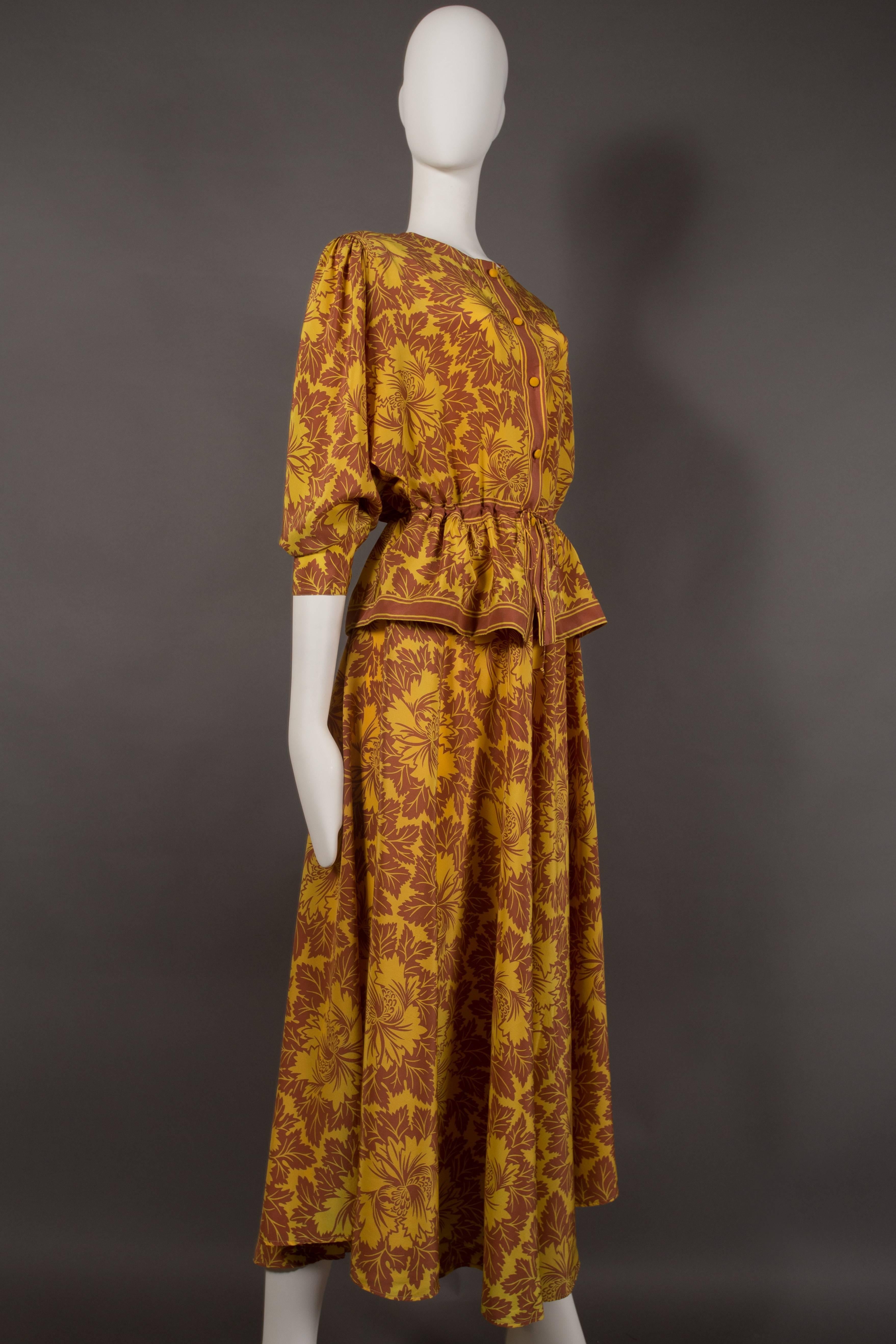 A Janice Wainwright silk pantsuit, circa 1970s. Super wide leg culottes with drawstring waist and two side pockets, peplum blouse with drawstring waist and button closure. 