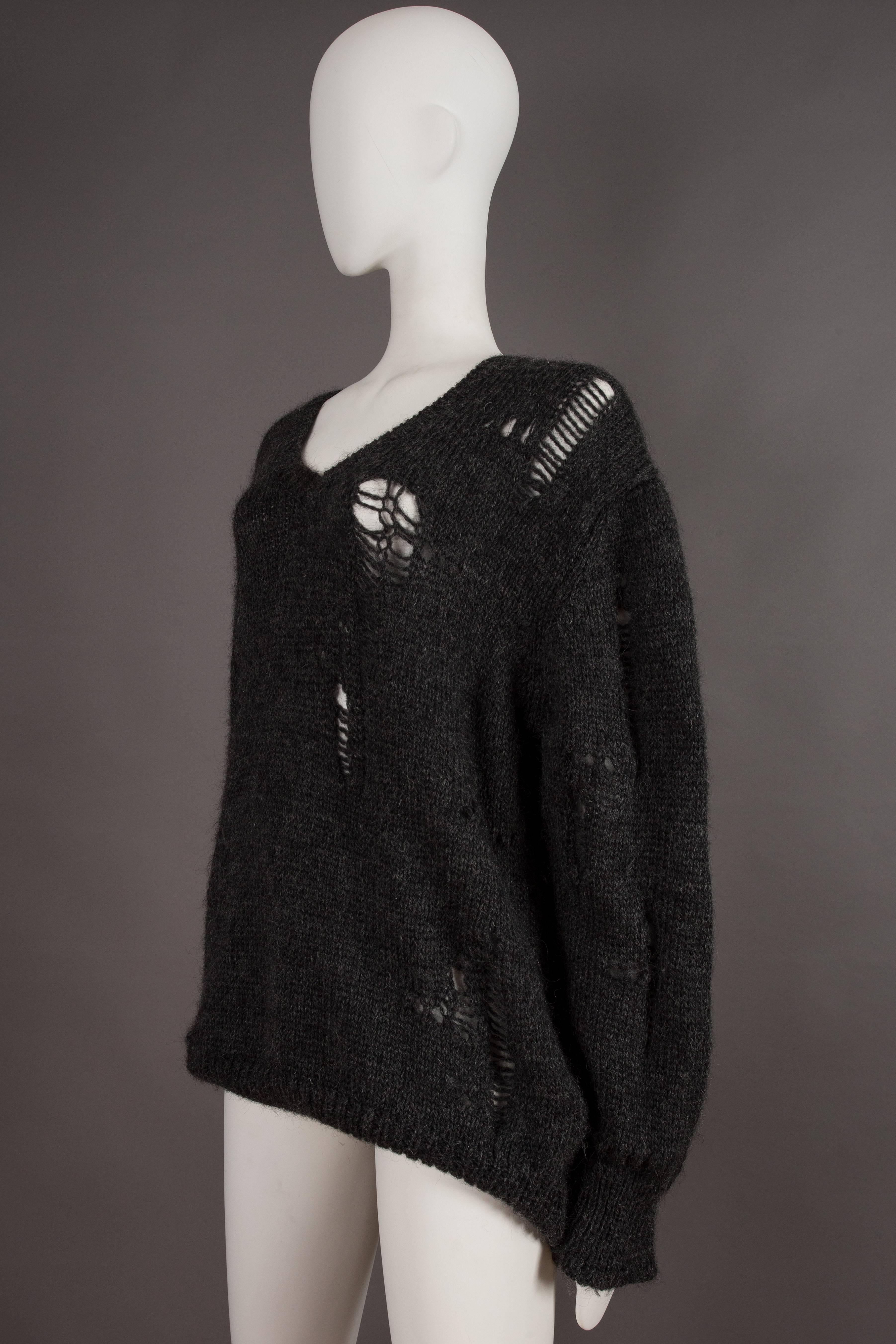 Black Comme des Garcons oversized sweater decorated with holes, circa 1982