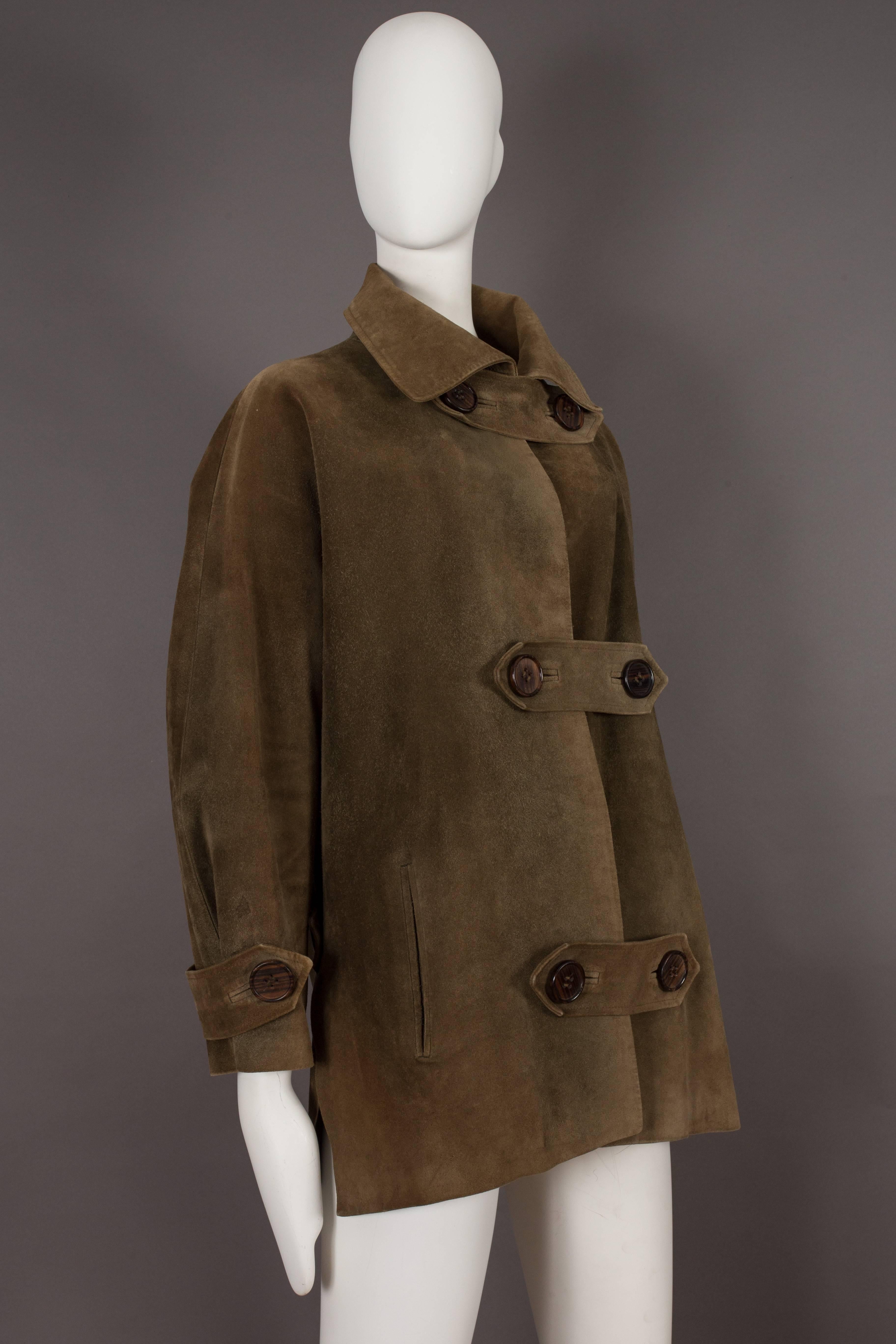 Extremely rare and important haute couture Yves Saint Laurent oversized suede coat from the autumn-winter 1963-64 'Chasuble and Cuissarde Boots Collection'.

The coat features double button closures made of wood throughout and silk lining. 