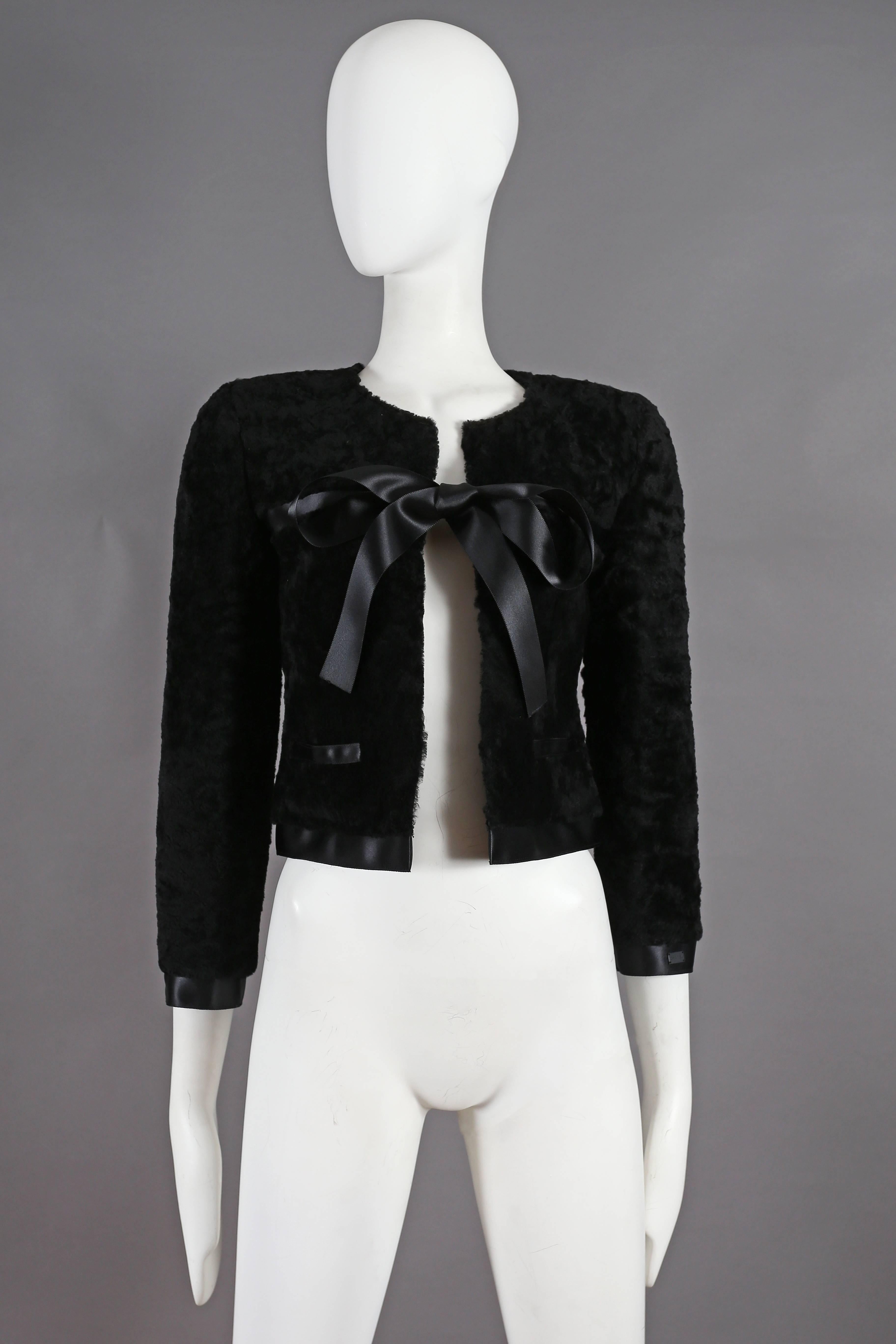 A Chanel black shearling cropped jacket with silk bow fastening and trim, from the autumn winter 2003 collection. 

