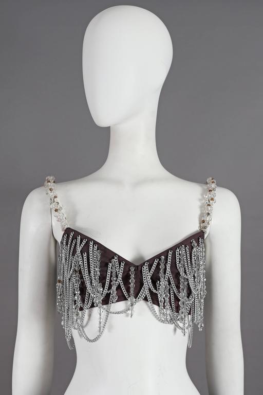 Early and rare Dolce & Gabbana bralette from the iconic Spring-Summer 1991 collection. The bralette features metal chain loops and beaded tassels throughout and beaded shoulder straps. 

As seen in Vogue Italia, May 1991 worn by Yasmeen Ghauri.
