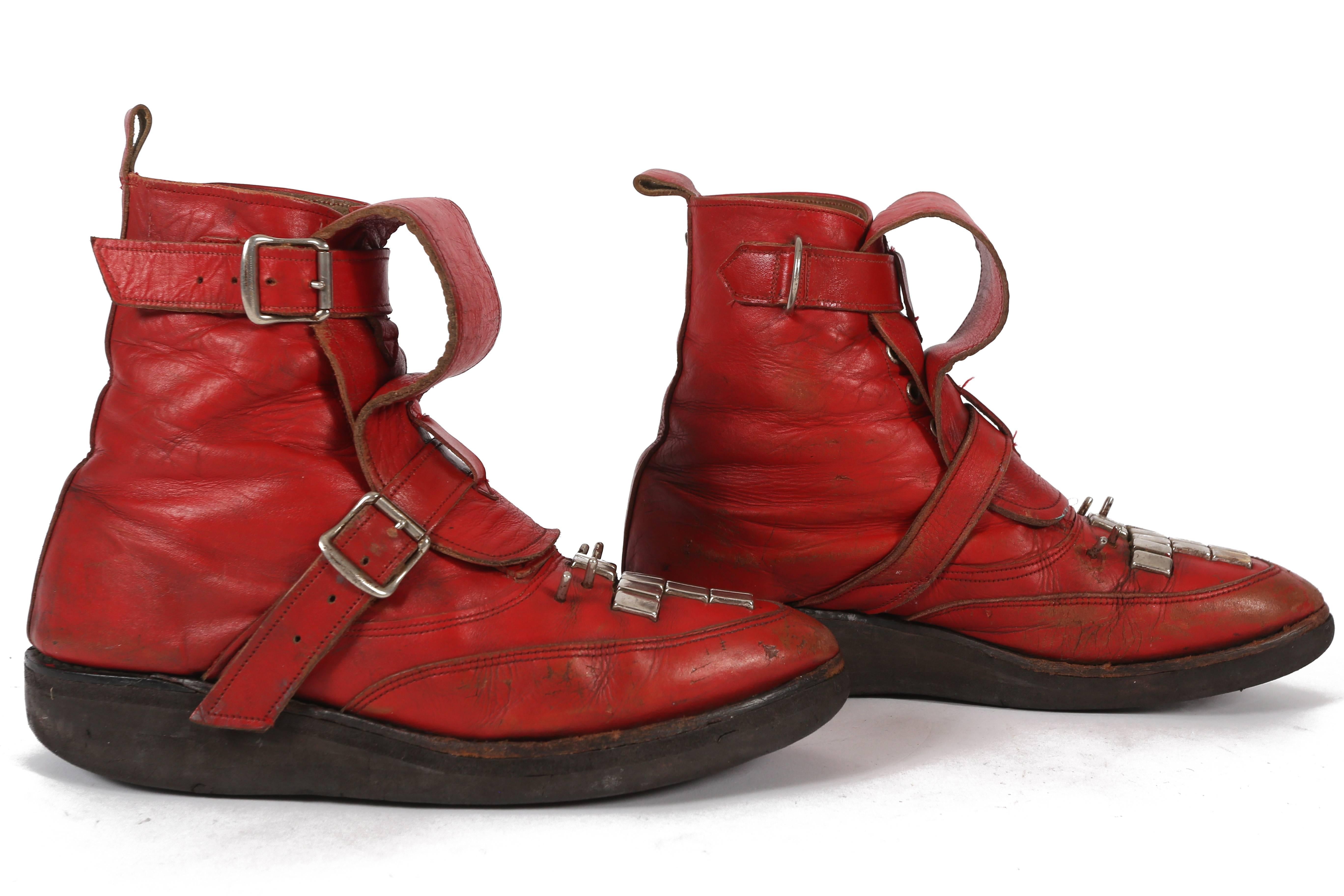An extremely rare pair of SEDITIONARIES ankle boots by Vivienne Westwood and Malcolm McLaren. Red leather, studded and fastening with buckles, with brothel-creeper soles and original label. 