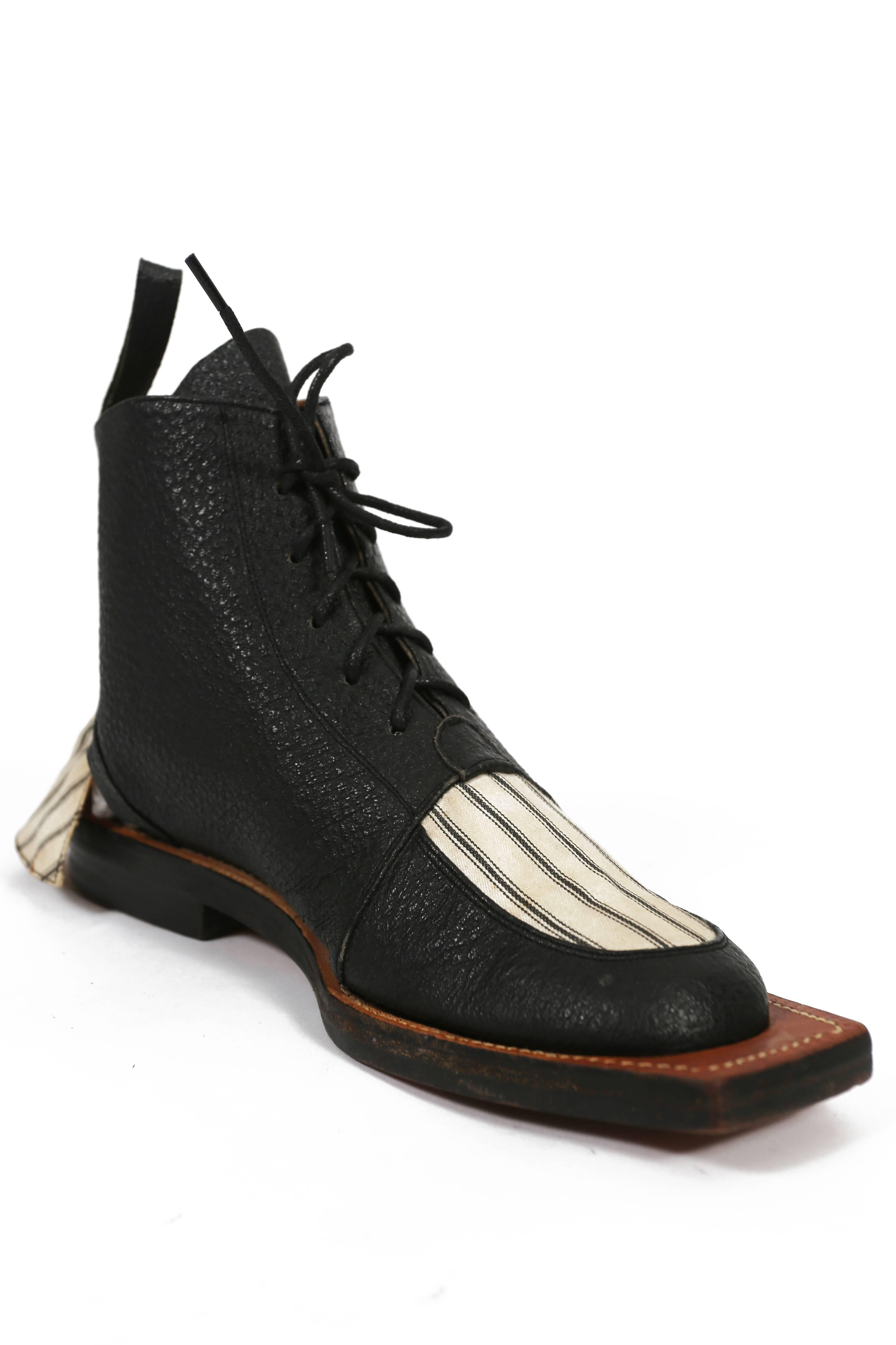 Extremely rare and early John Galliano leather hammerhead boots from the 'Fallen Angels' collection, spring-summer 1986. Square toe, open ankle with striped canvas flap, lace up fastening, leather soles, and wooden heel. Galliano collaborated with