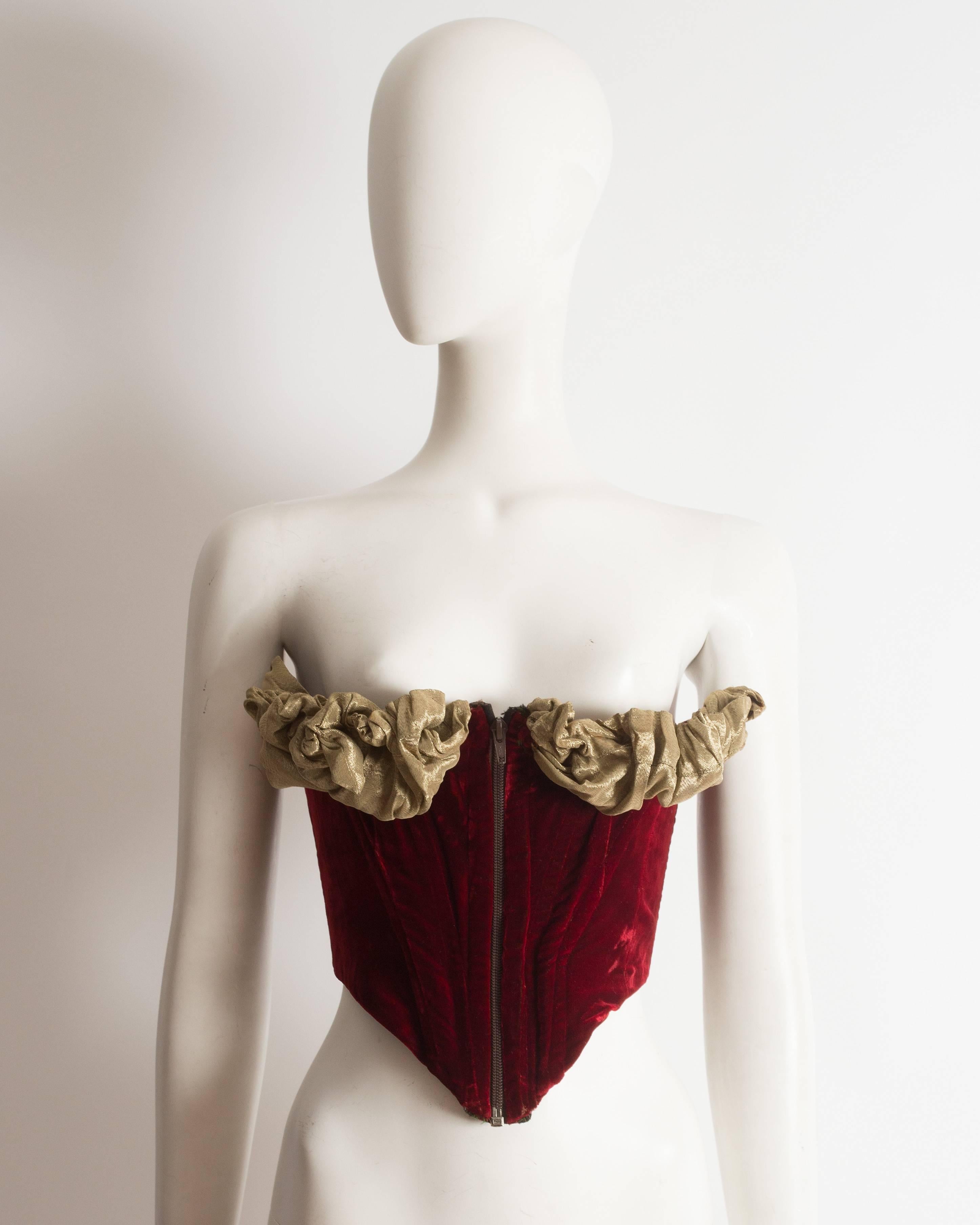 Important and rare Vivienne Westwood red velvet corset with pleated bust with internal wiring.

‘Voyage to Cythera’, Autumn-Winter 1989