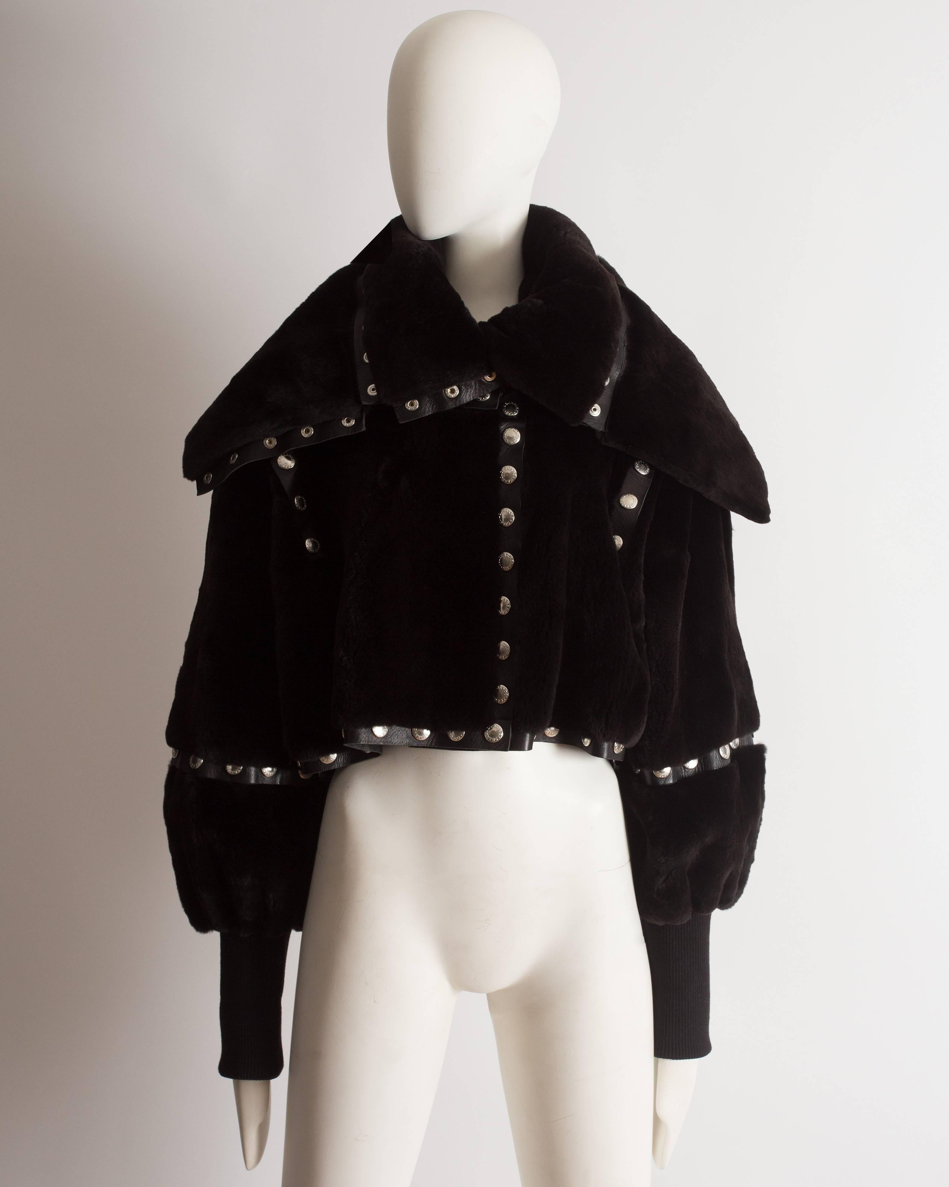 Dolce & Gabbana cropped fur jacket constructed in incredibly soft black sheared beaver fur and leather. The jacket features 146 silver stud button closures throughout and can be adjusted to a short sleeved or collarless jacket. 

Autumn-Winter