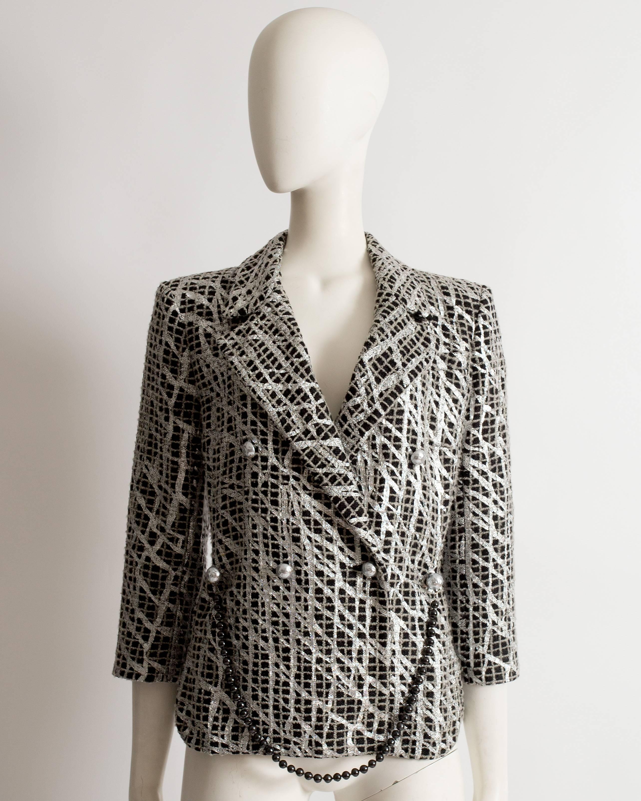 Limited edition Chanel evening jacket constructed in a black and gray checked tweed decorated with metallic silver paint in a graffiti style. Removable beaded chain belt, large silver button closures throughout and silk lining.