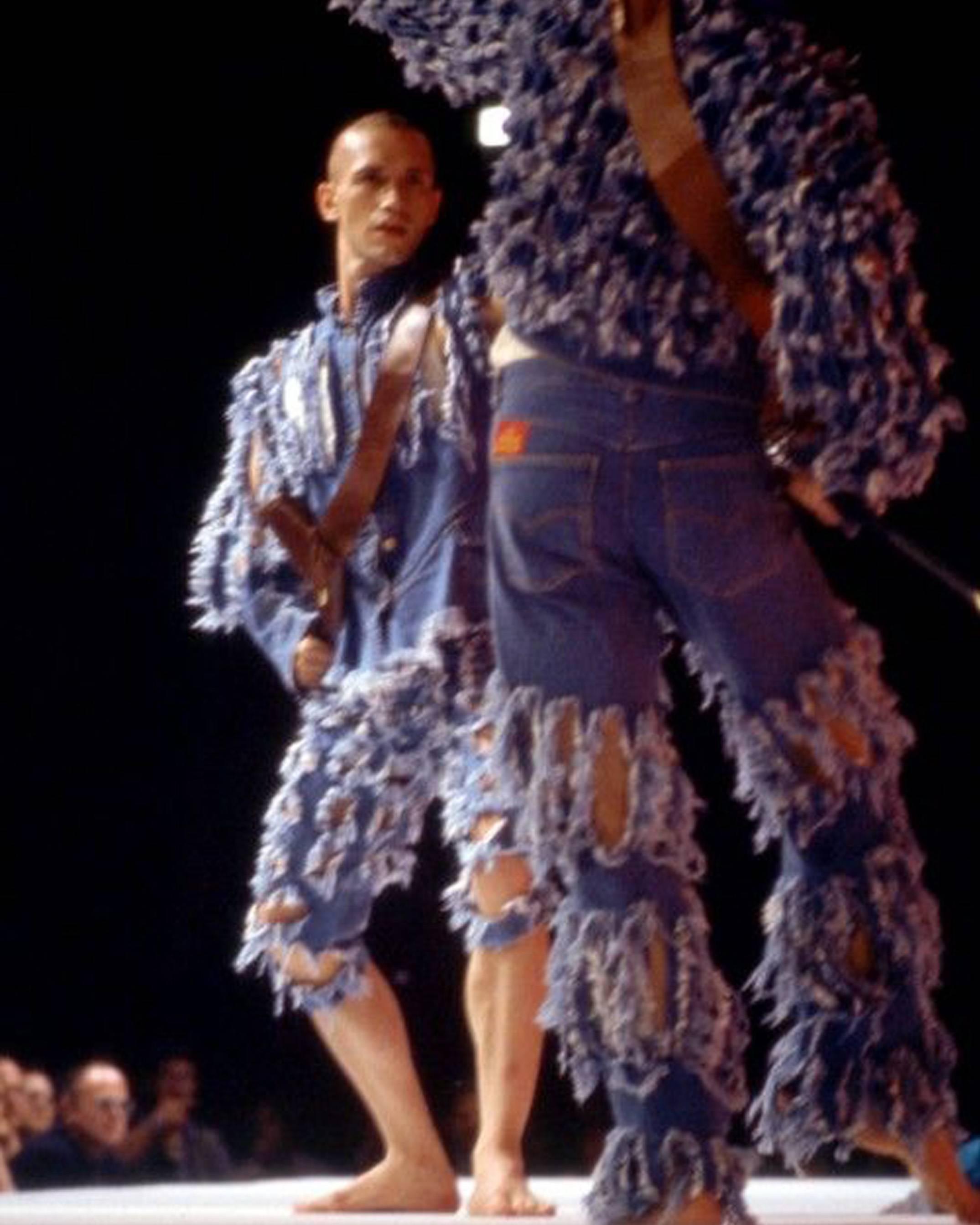 Introducing an iconic archival piece from Vivienne Westwood Men's 'Cut, Slash and Pull' Spring-Summer 1991 collection. This ensemble showcases the designer's revolutionary approach to fashion and rebellion against conventional norms.

The long