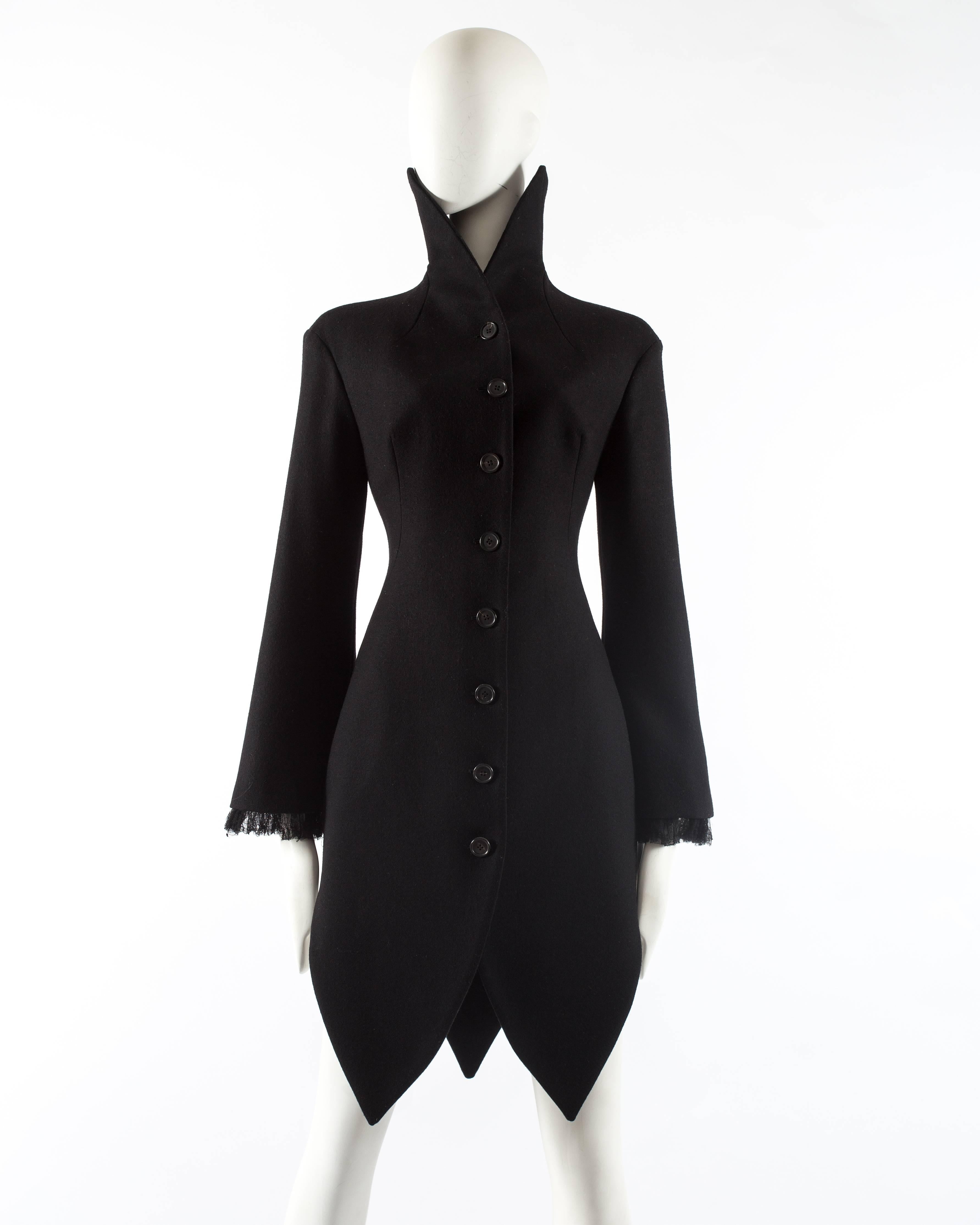 Introducing a striking Alexander McQueen black wool evening coat from the autumn-winter 2008 collection. This coat embodies the designer's exceptional craftsmanship and innovative design.

With its eight-button closure at the front, the coat exudes