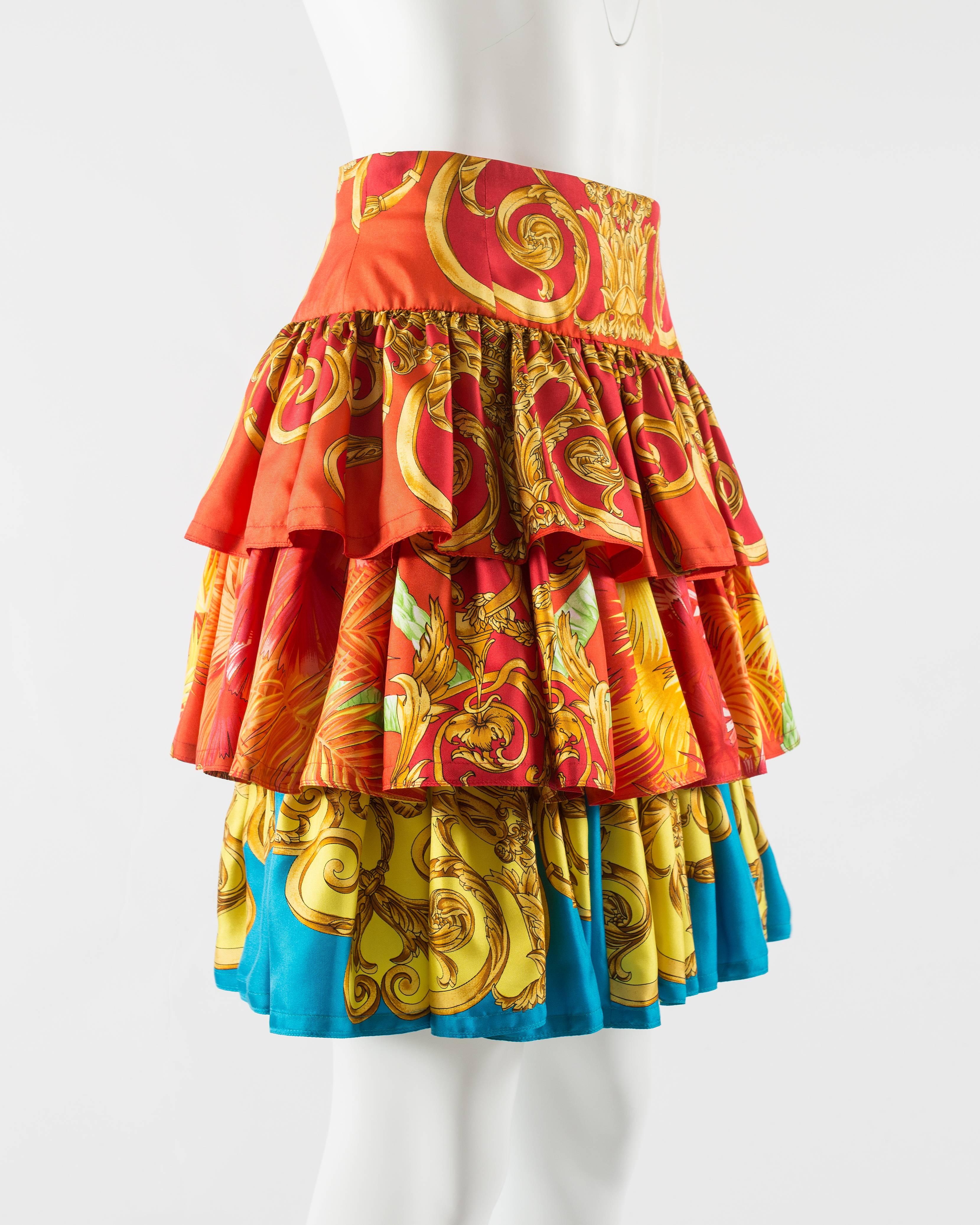 Introducing the exquisite Gianni Versace Baroque printed silk tiered ruffled skirt, a true masterpiece that captures the iconic essence of Versace's bold and opulent style.

Adorned with signature Versace baroque prints in a stunning palette of red,