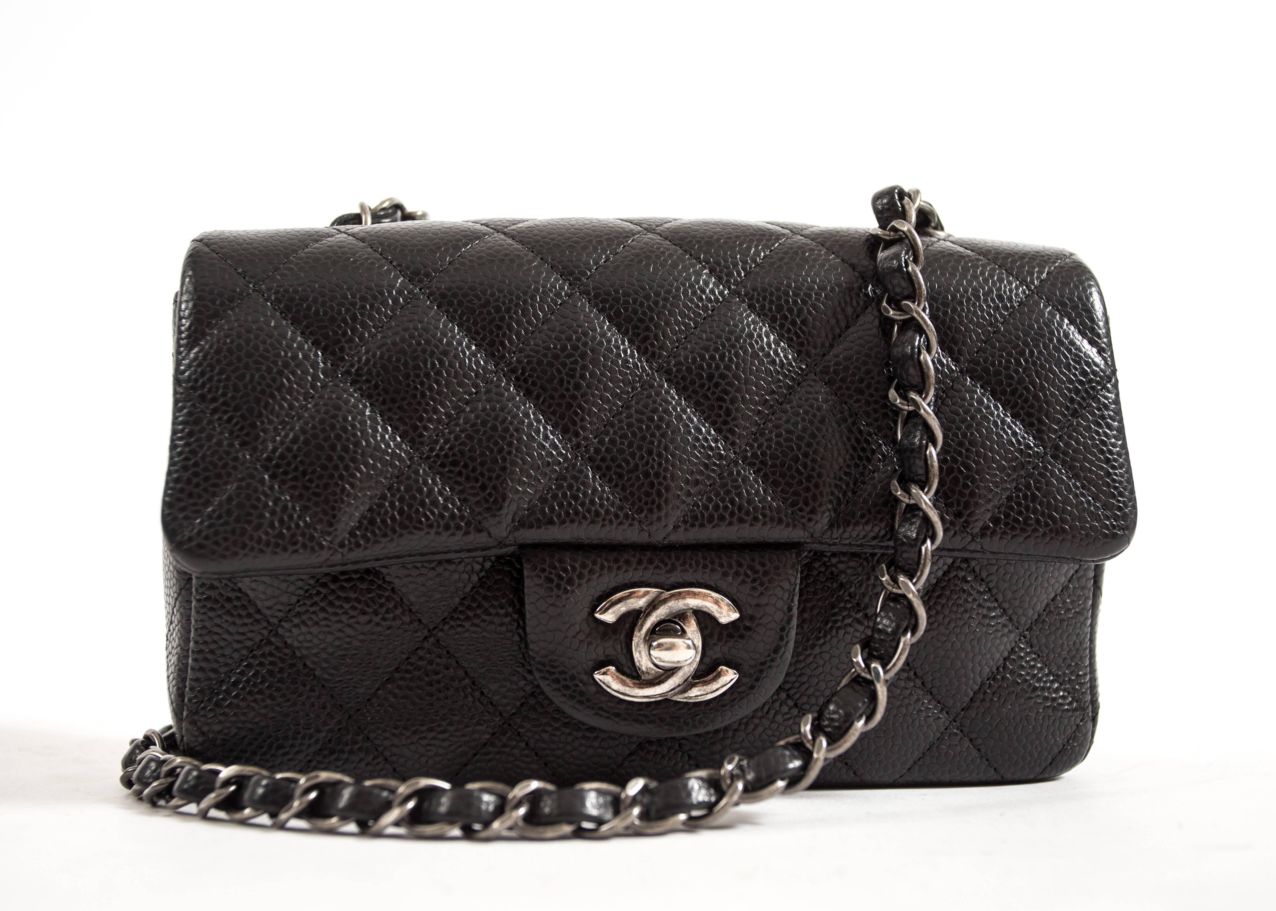 Chanel Black Caviar Mini Classic Crossbody Flap Bag

- Chanel Mini Flap bag of black caviar leather with aged ruthenium hardware.
 
- Front flap and with CC turn-lock closure, a half moon back pocket, and an interwoven chain link with black leather