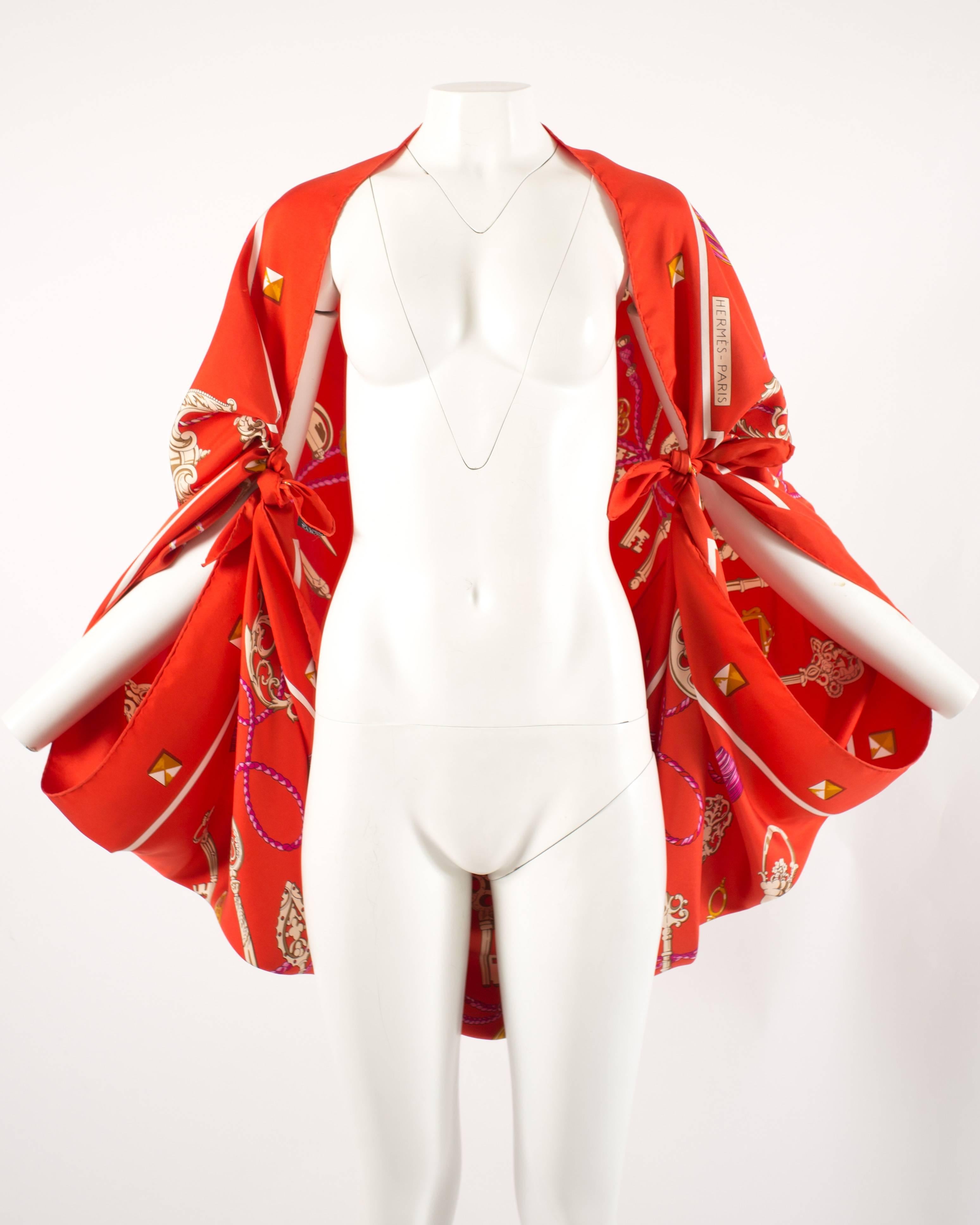 Hermes red Giant Silk Scarf with 'Les Cles' print by artist Cathy Latham 

Versatile design which can be worn as a classic scarf, halter neck dress, bolero jacket, or hobo bag.  

Design history - 