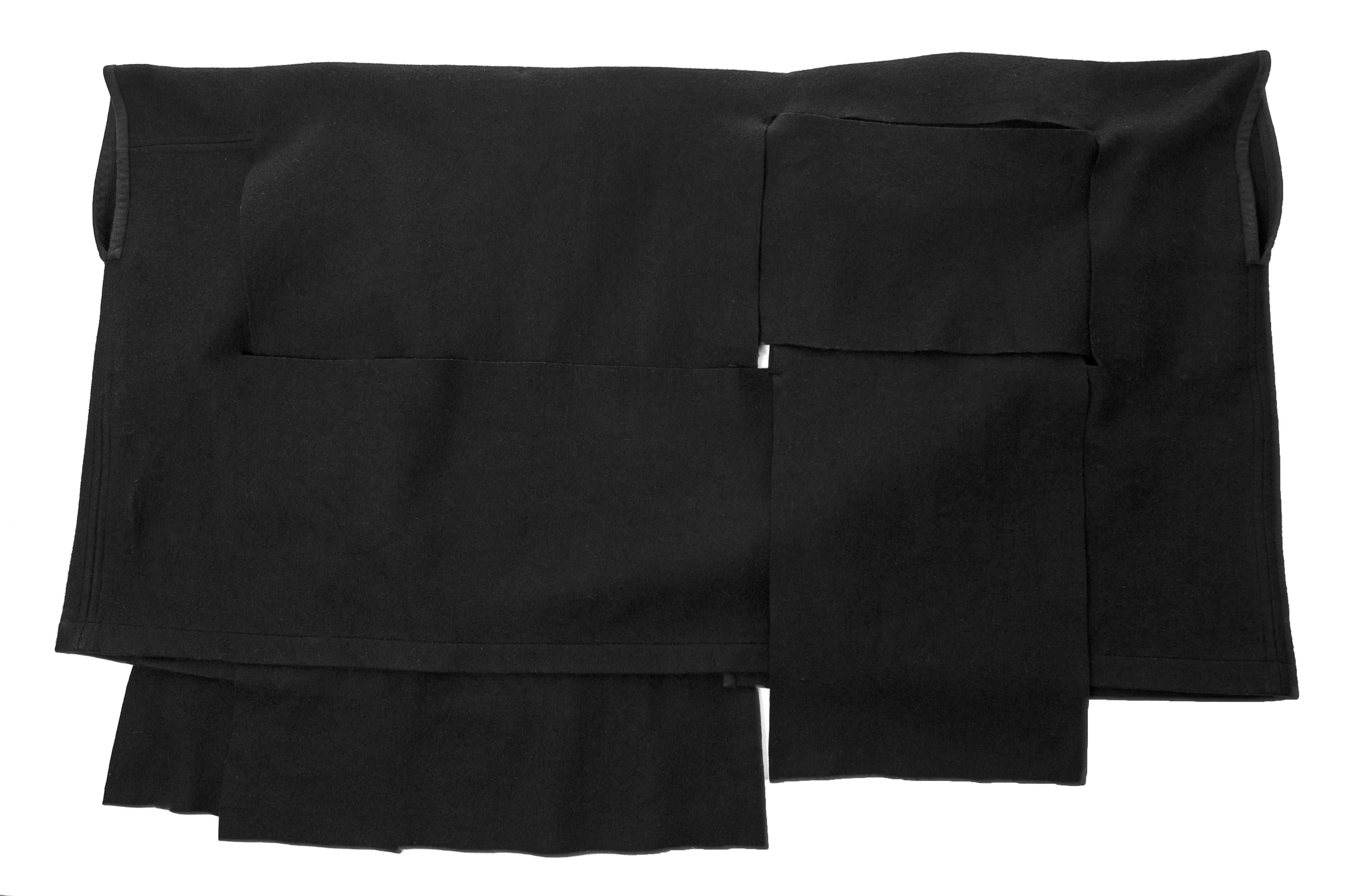 Black Comme des Garcons black wool coat constructed from large woven panels, AW 1983