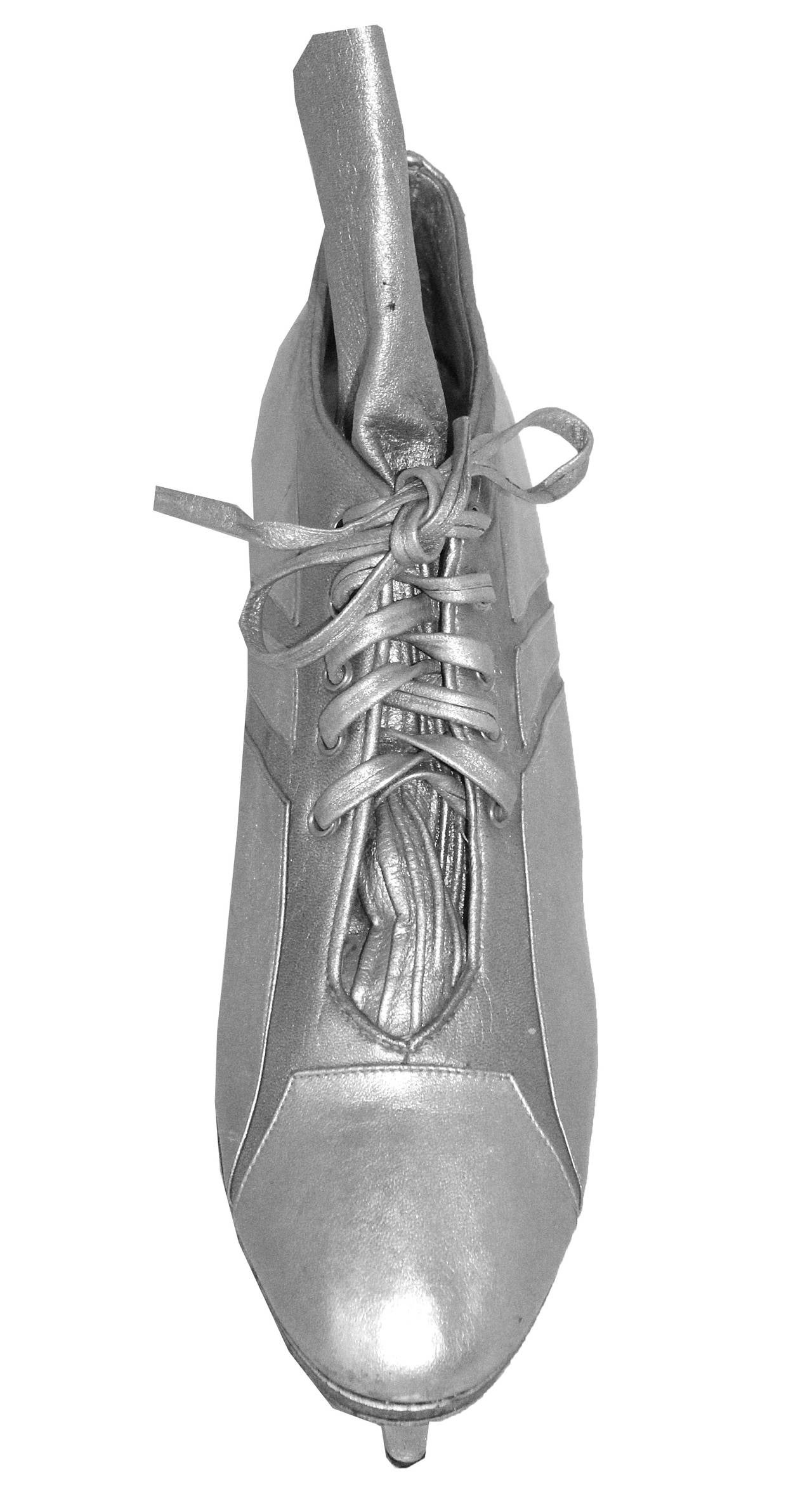 A pair of metallic silver boots designed for Jean Paul Gaultier by Massaro Paris. The inspiration behind the design were football boots and the idea of extending the height. 

The boots were designed for the Spring/Summer 1993 runway show and are
