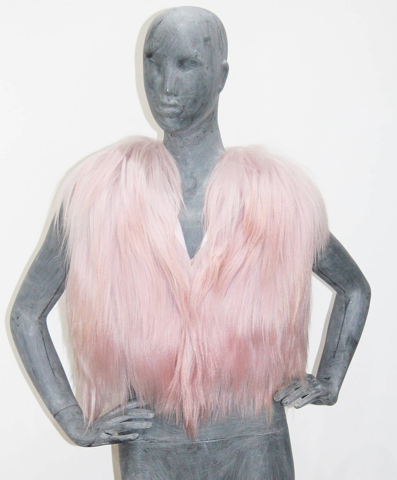 A yak fur gillet by Christian Dior in a pastel/dusty pink. The gillet has two hook and eye closures and 100% silk pink lining. 

Size Small/Medium