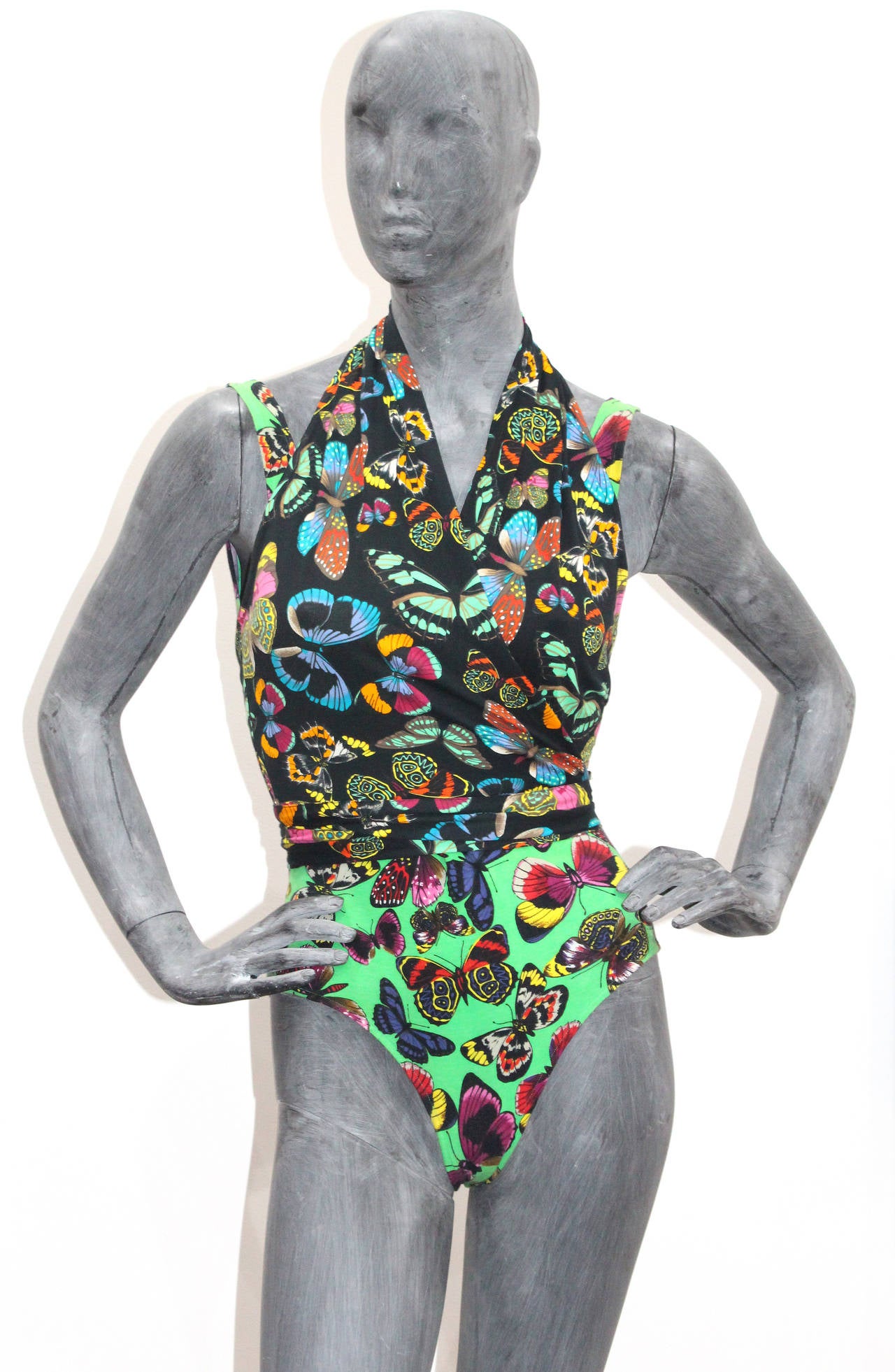A beautiful and fun bodysuit and halter neck wrap top ensemble by Kenzo Paris designed in the 1990s. The ensemble includes a halter neck wrap top and leotard with scoop neck and low back. The ensemble would work as a bathing suit at the pool party
