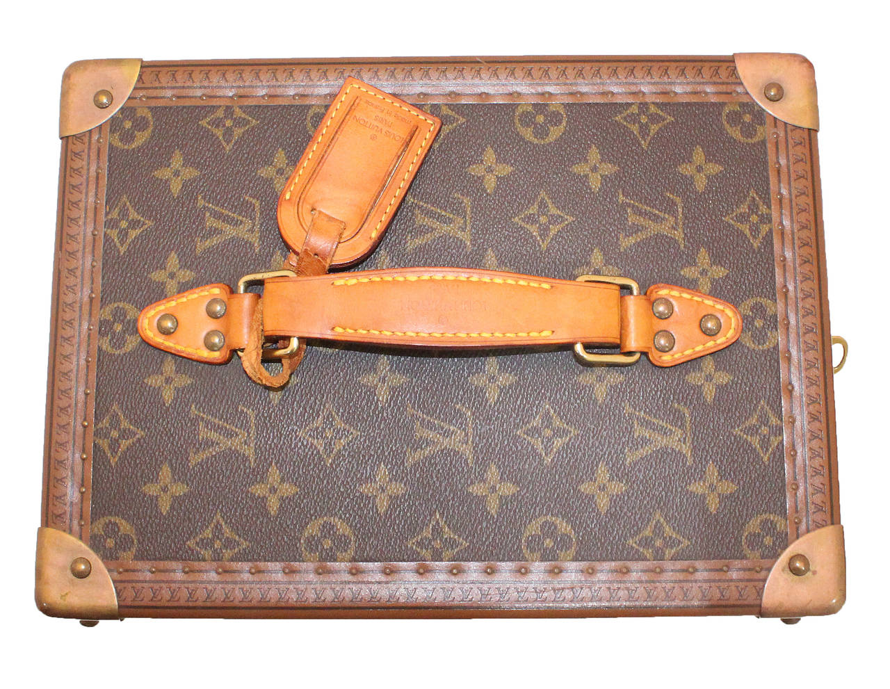 The iconic Louis Vuitton vanity case in the classic monogram with golden brass hardware. The interior in a cream leather with three holders made from a tan leather. The case also comes with a smaller box which has a mirror inside. The case can be