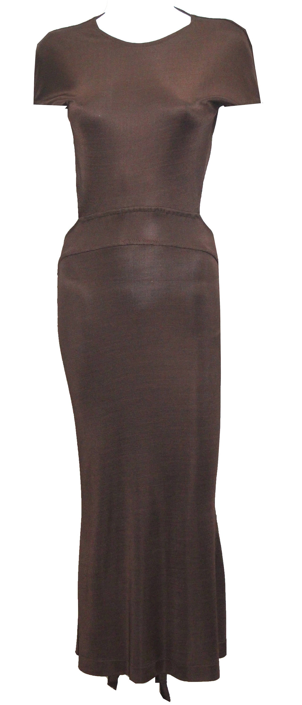 A backless evening gown by Claude Montana in a chocolate brown viscose from the 1980s. The dress has a pleated back tail, cut out back and snap button closure. 

Size Small