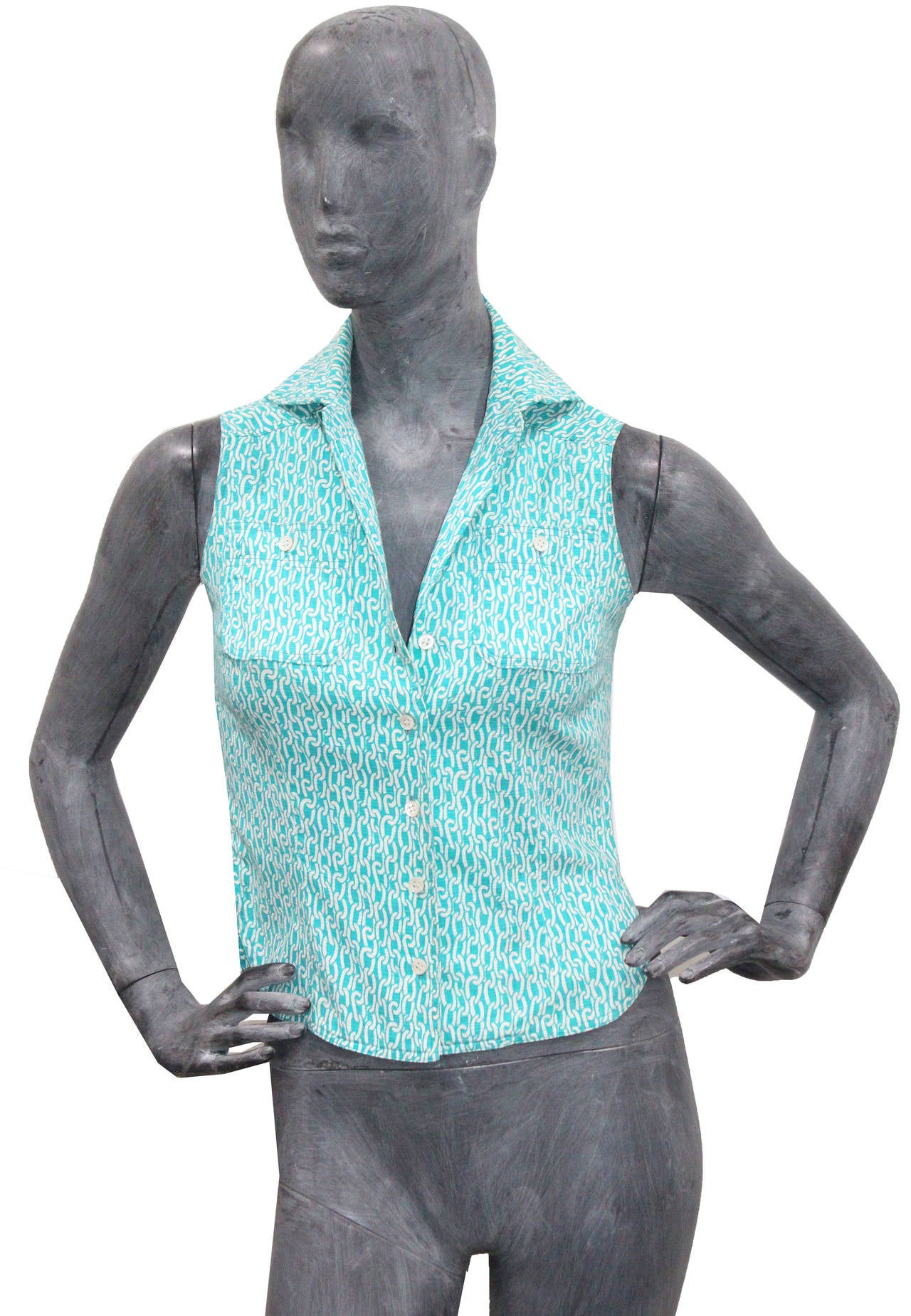 A 1970s Hermes cotton button up collared vest in a aqua and white link print. 

Small