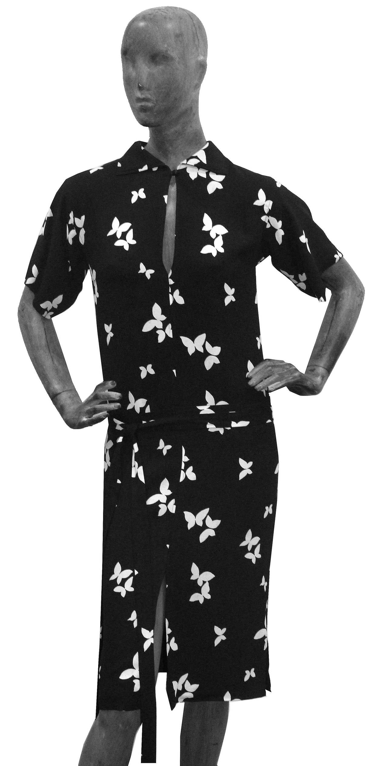 A rare Yves Saint Laurent moss crepe dress from the Spring/Summer 1978 collection. The dress features a butterfly abstract in print in contrasting black and white, extra long tie up waist belt, front and side slits and 1 button up collar. The dress