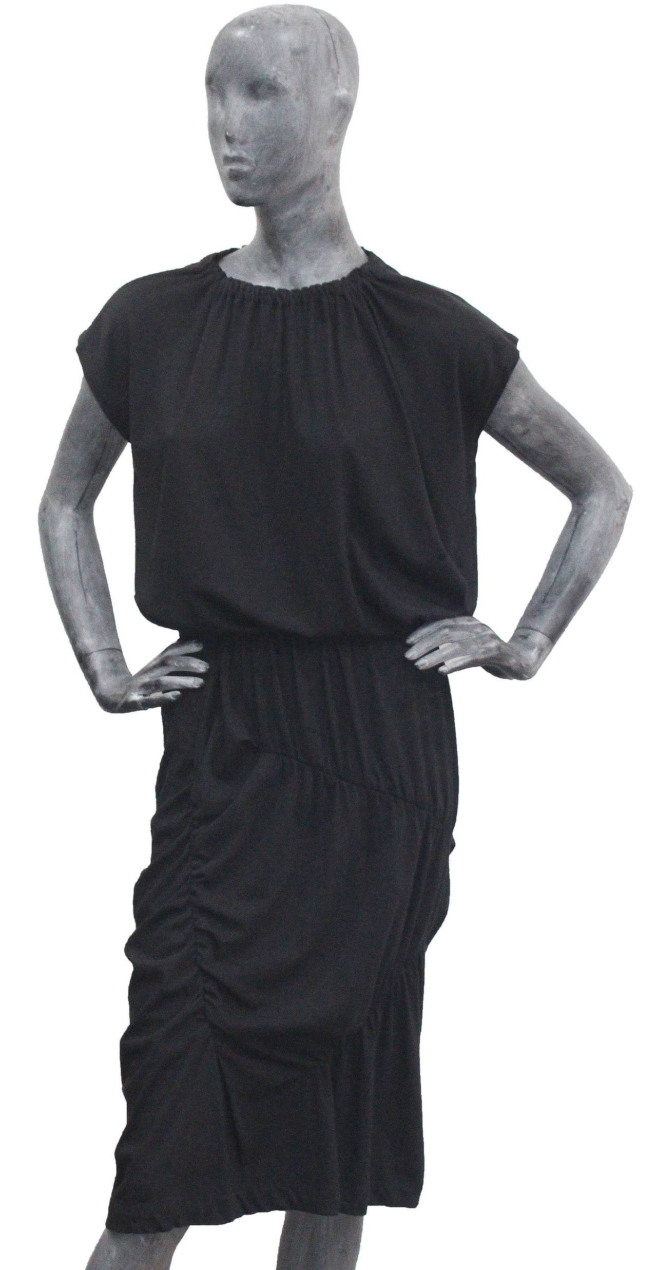 A COMME des GARCONS deconstructed black jersey dress from the 1980s. 

Tricot Label