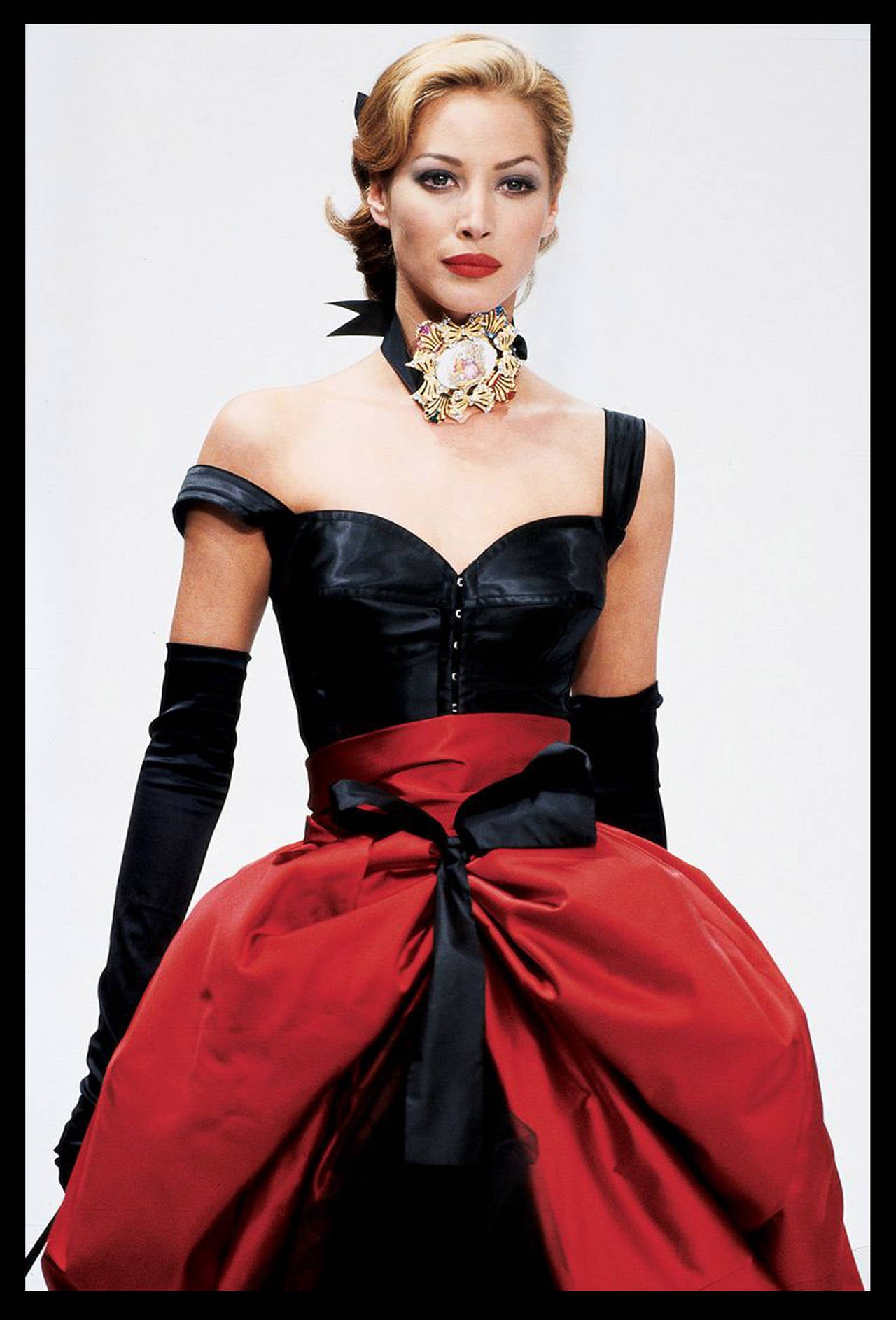 The iconic red silk tie up skirt by Dolce & Gabbana from the Autumn/Winter 1992 collection as seen on Christy Turlington on the Milan catwalk. The skirt is in a royal red and 100% silk. The design of this skirt involves two black ribbons, one which