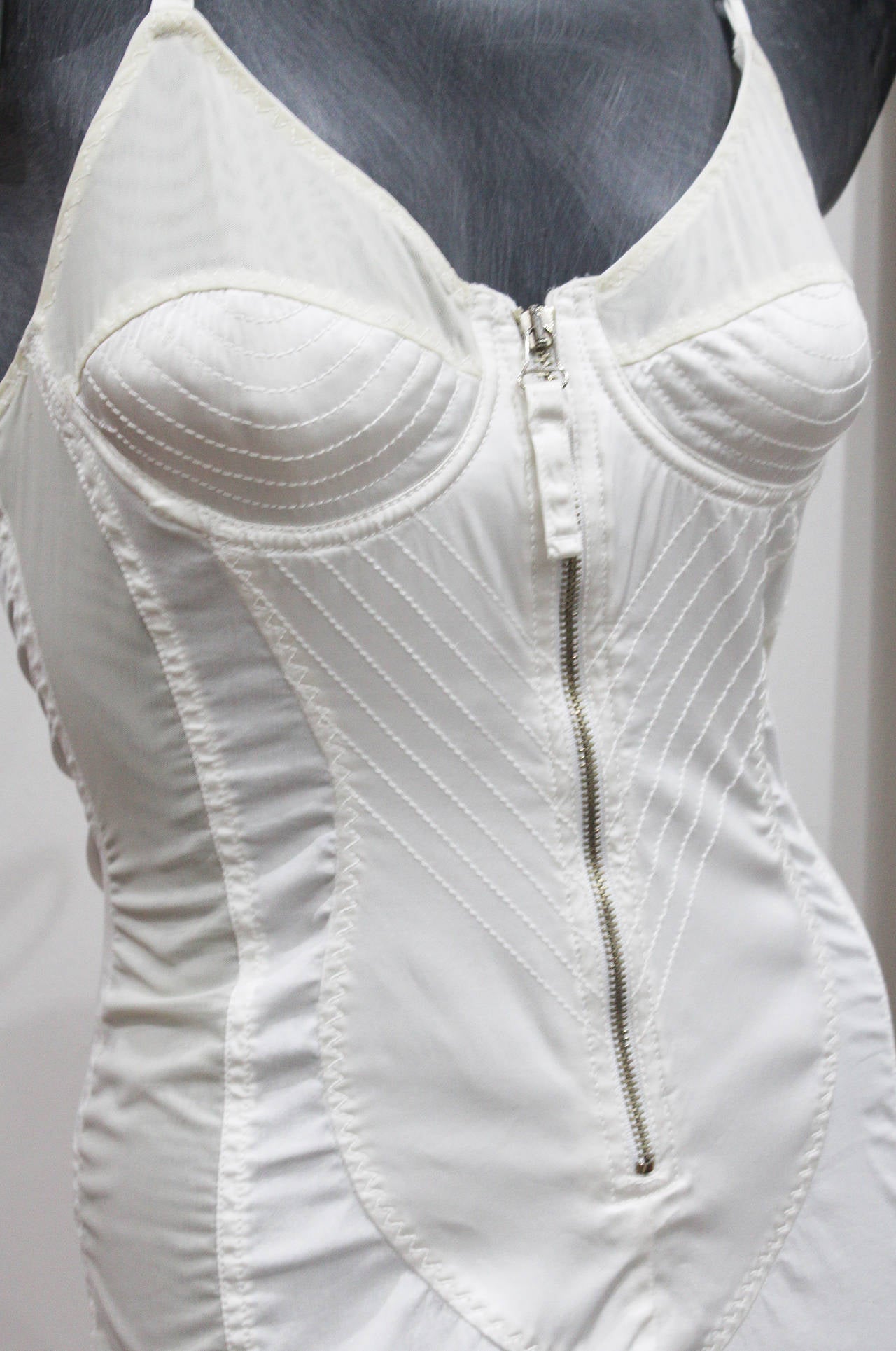 Jean Paul Gaultier corset dress. white satin with white stretch cotton, inside pockets to insert pads for the ultimate Gaultier/Madonna look and silk tie up halter neck design. Lace up back with metal zippers. circa 1987, France. 

Size: Fr 38 - 40