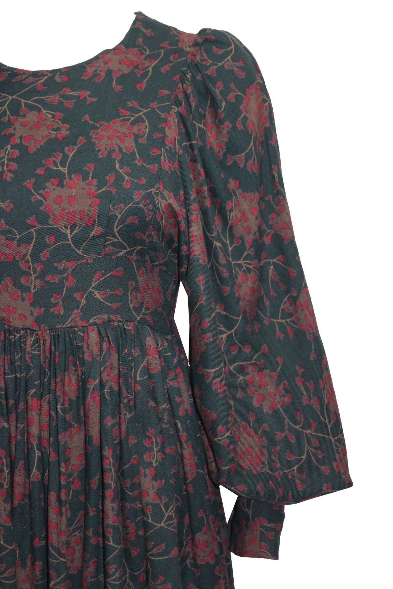 A rare and early mini dress by BIBA from the late 1960s. This dress has wonderfully billowing poet sleeves with button up exaggerated cuffs, pleated skirt finishing just above the knee, a love heart print in trees and a zipper running at the