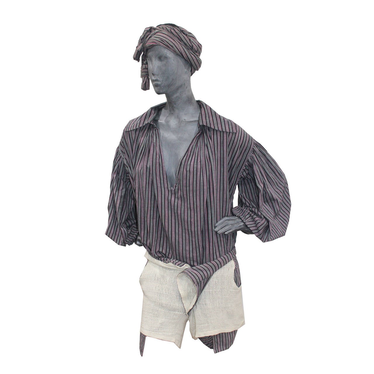 A Fine and rare World's End pirate ensemble from Vivienne Westwood and Malcolm McLaren's first catwalk show. Made of 100% Cotton. The ensemble features an oversized pirate shirt, mini shorts and a tasseled sash which can be be styled in various