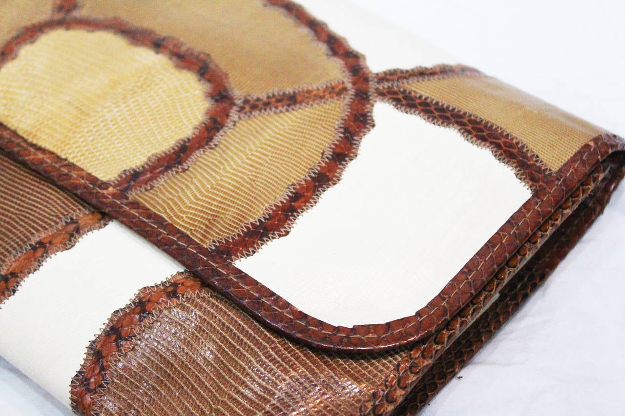 A truly unique and chic Carlos Falchi patchwork clutch with a pink leather interior from the 1970s.