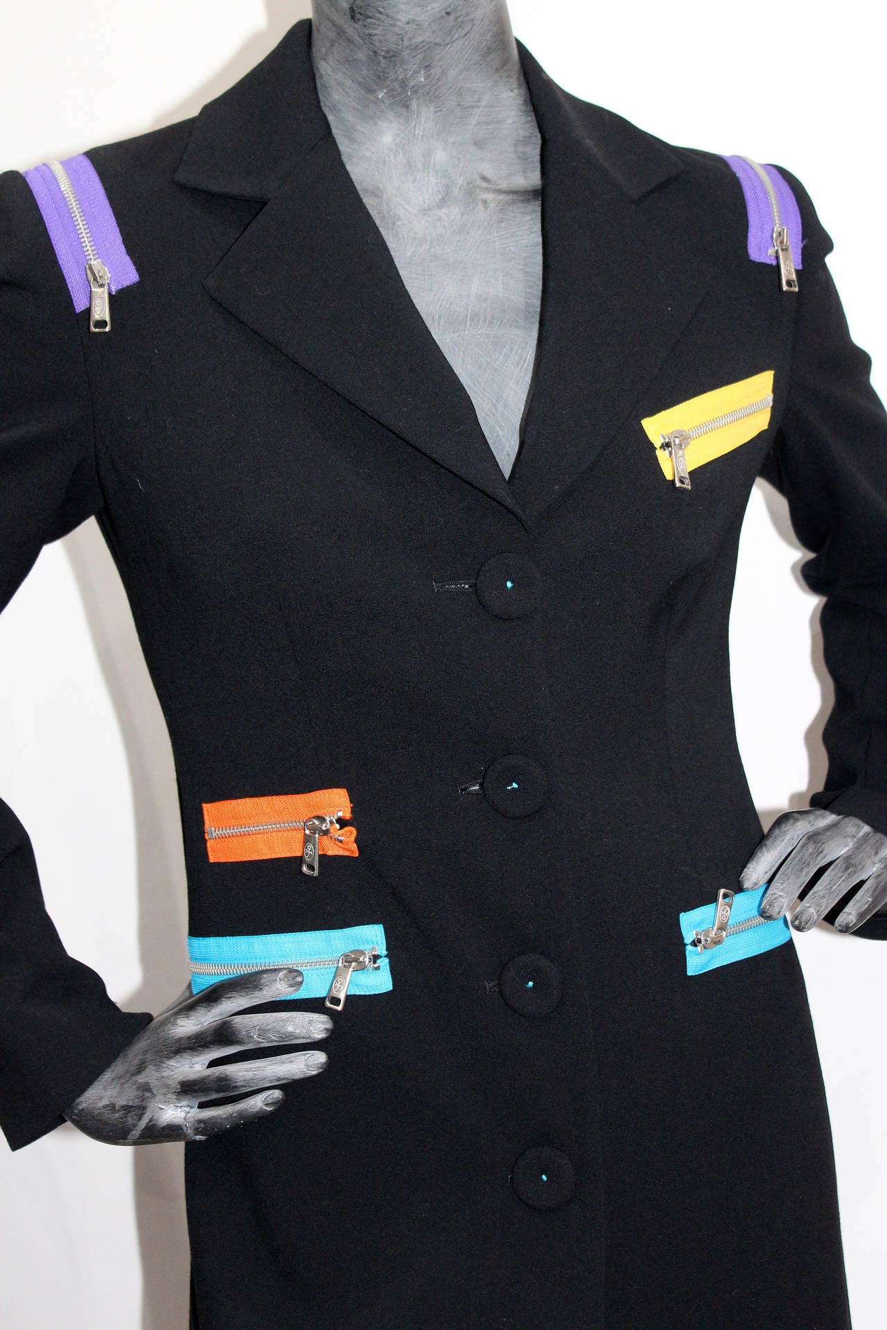 a 1990s Jean-Charles de Castelbajac black wool tailored coat with multicoloured zips and four front pockets.

Size: (not labeled) Approx. Fr 38-40 / UK 8-10

Condition: Excellent, appears unworn