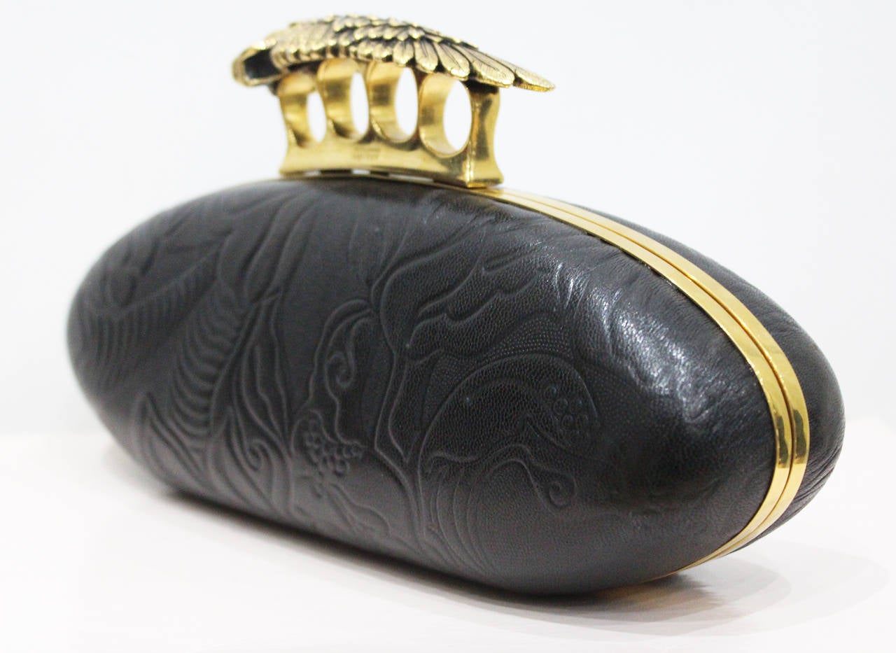 A fine and rare black leather embossed large knuckle duster clutch bag by Alexander McQueen. This clutch is from the last collection Alexander McQueen designed and was released after his death. The collection was inspired by Byzantine art, the
