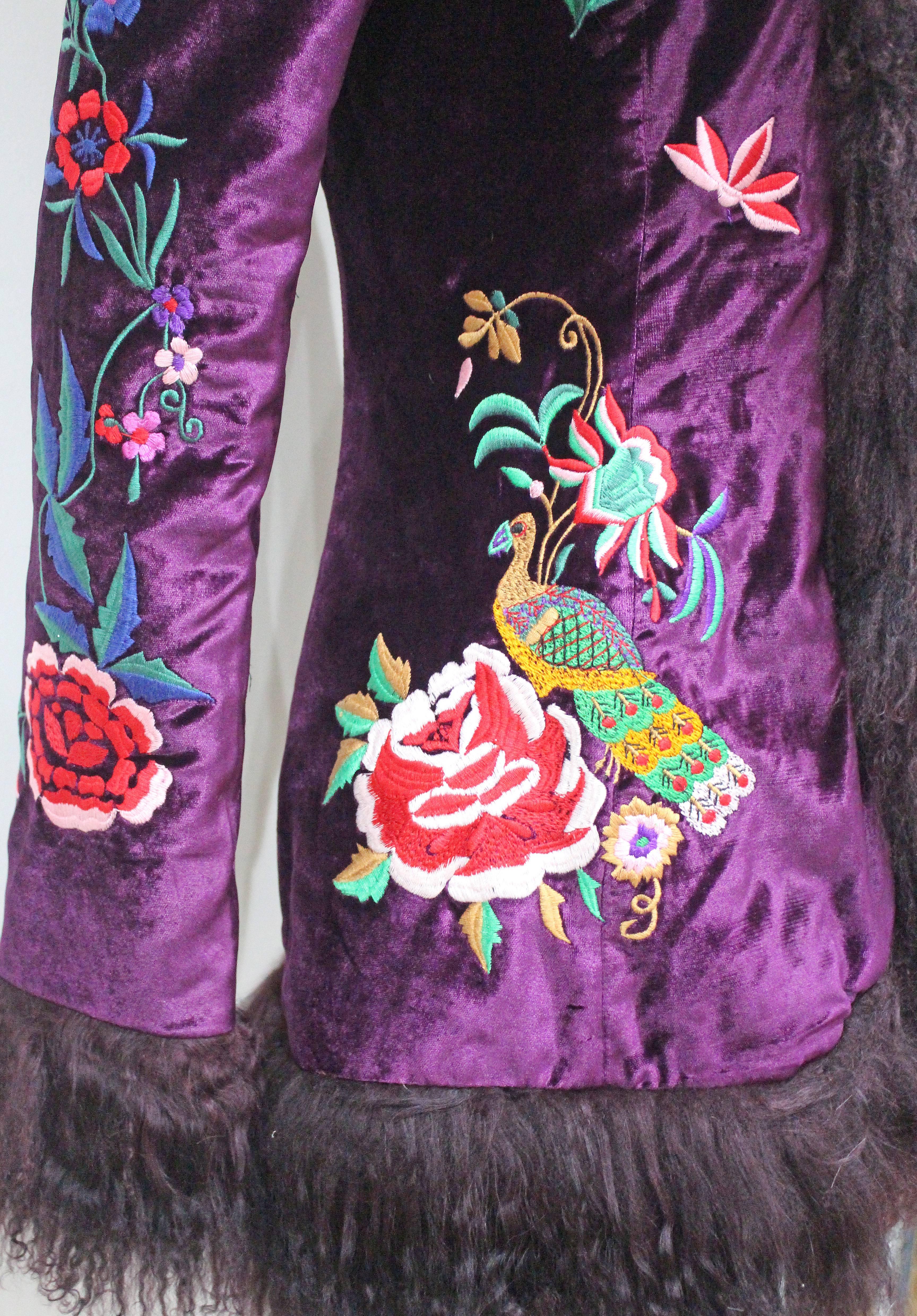An exceptional evening jacket by 'D & G' - Dolce & Gabbana. The jacket is of a high quality purple velvet with beautiful embroidery through out in a signature Dolce & Gabbana style. The cuffs, collar and hem are all trimmed with Mongolian lamb fur.