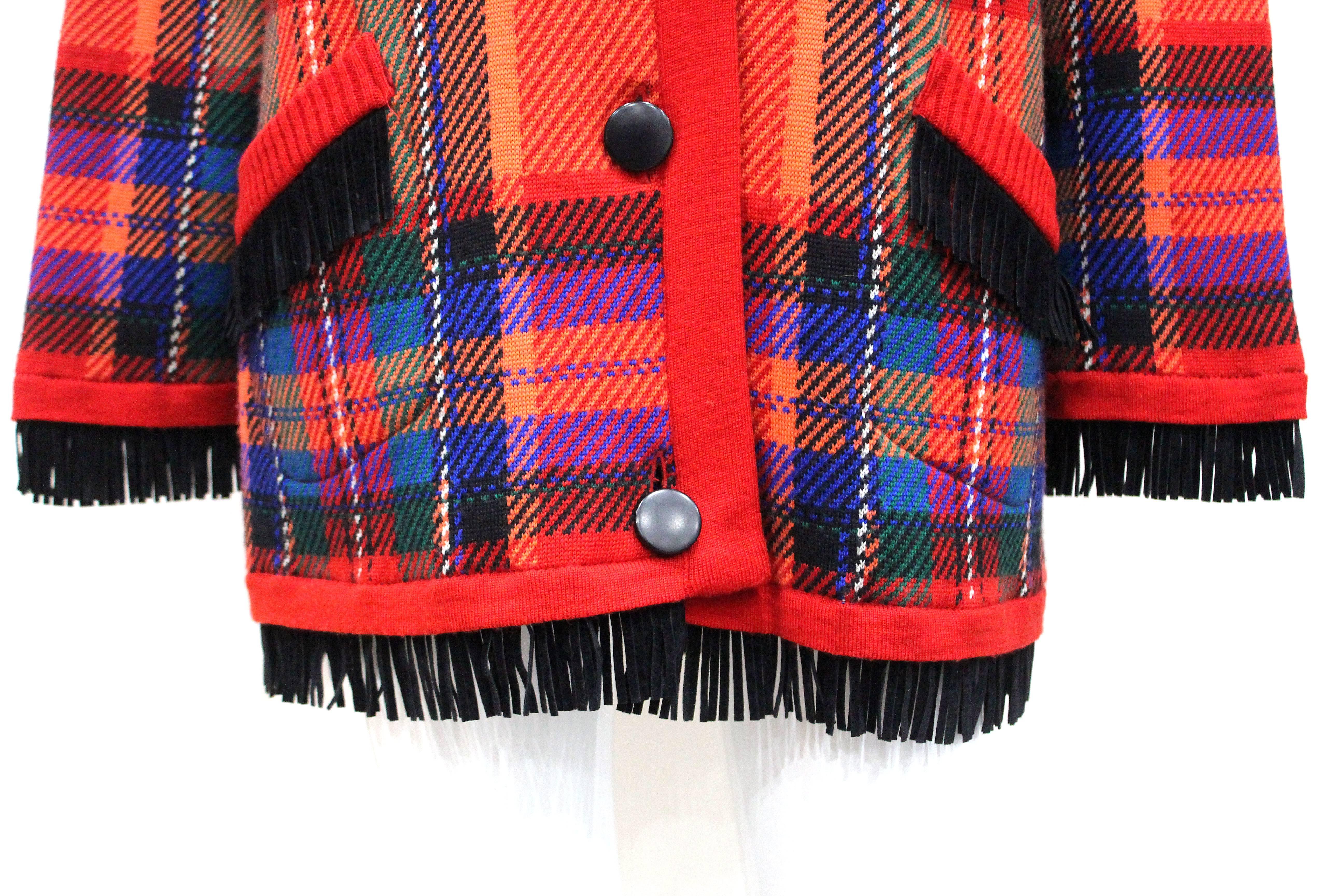 A winter wool cardigan jacket by Yves Saint Laurent from the 1970s. The jacket is in a plaid pattern and has black suede fringing throughout.

Fr 40 

Condition: Overall great vintage condition, the only flaw is a minute snag on the collar which